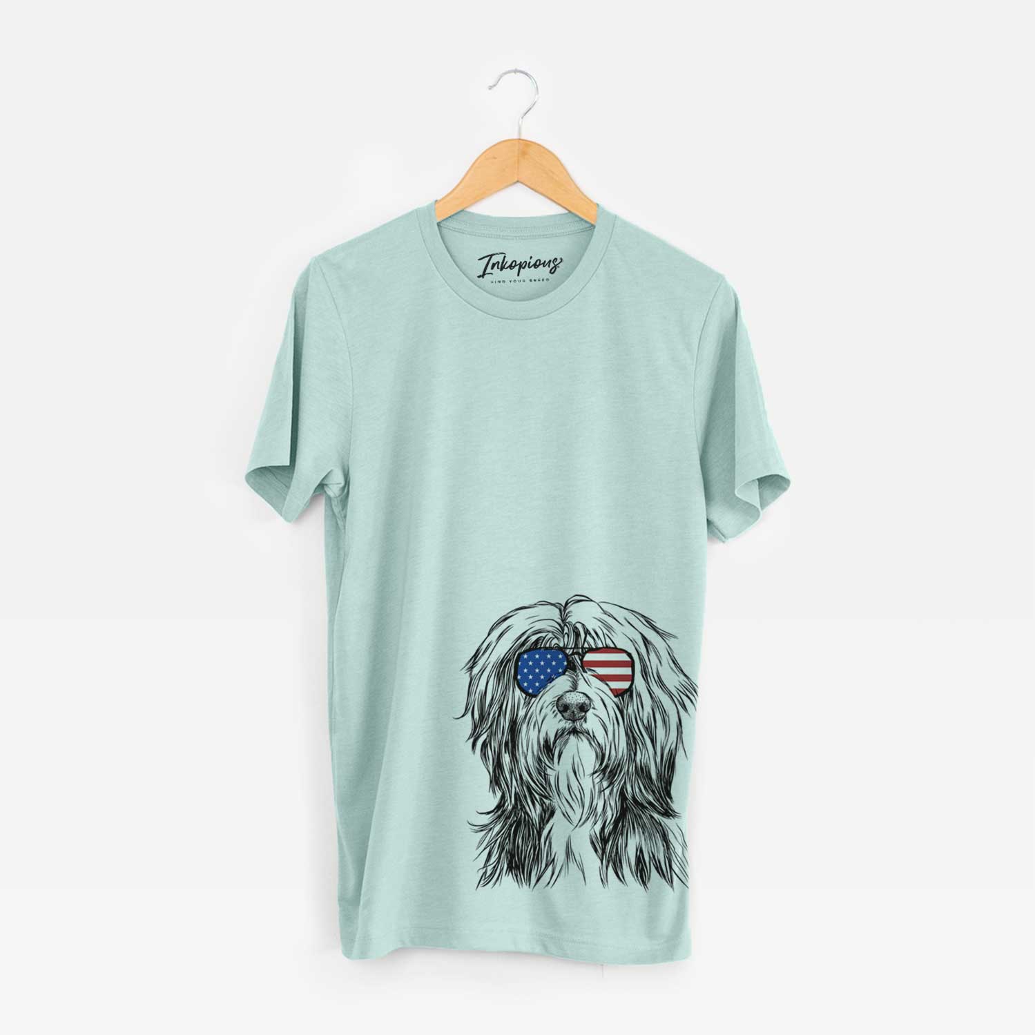 Hand-drawn sketch of Fiji the Polish Lowland Sheepdog wearing American flag sunglasses on a Heather Sage Unisex crewneck