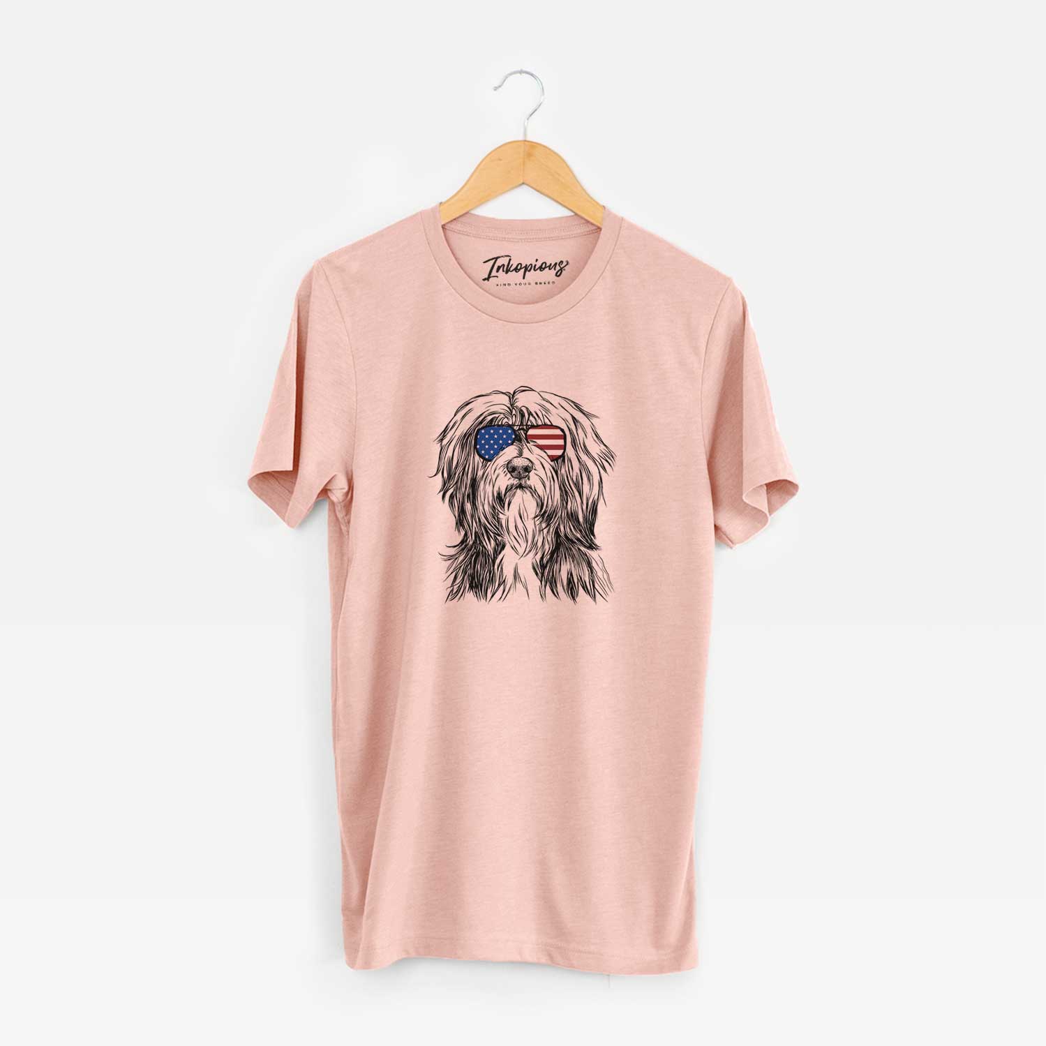 Hand-drawn sketch of Fiji the Polish Lowland Sheepdog wearing American flag sunglasses on a Peach Unisex crewneck