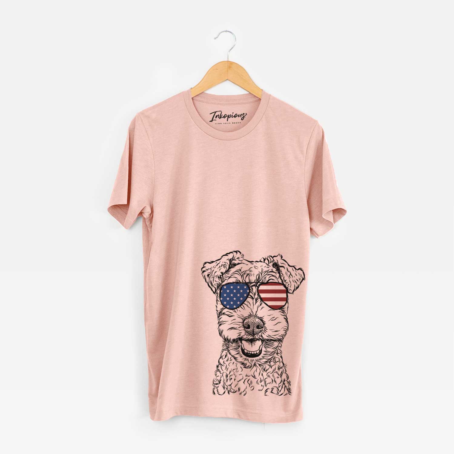 Hand-drawn sketch of Fintan the Irish Troodle wearing American flag sunglasses on a Peach Unisex crewneck