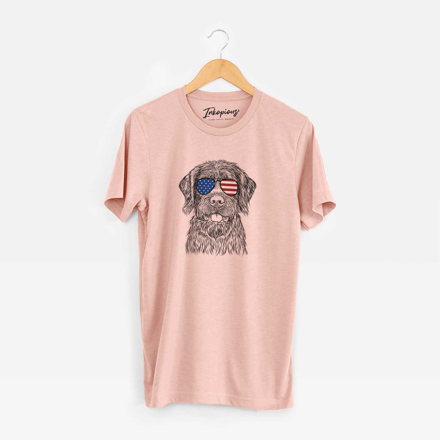 Hand-drawn sketch of Fletcher the Wirehaired Pointing Griffon wearing American flag sunglasses on a Peach Unisex crewneck