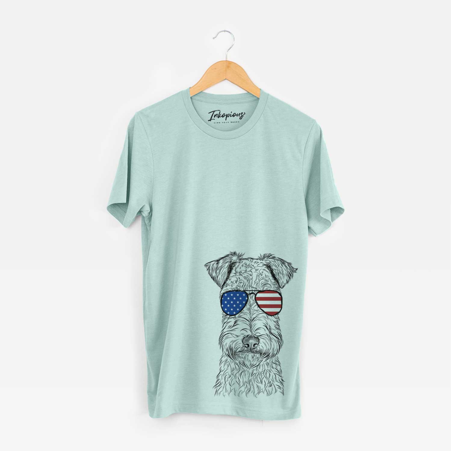 Hand-drawn sketch of Frida the Lakeland Terrier wearing American flag sunglasses on a Heather Sage Unisex crewneck