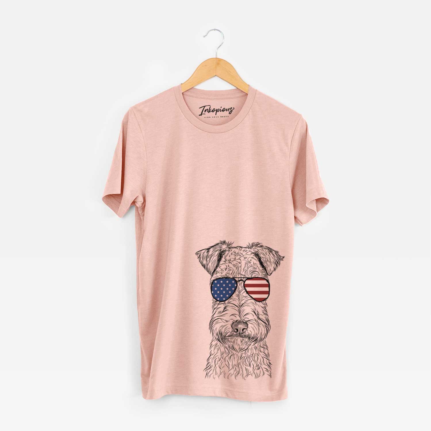 Hand-drawn sketch of Frida the Lakeland Terrier wearing American flag sunglasses on a Peach Unisex crewneck