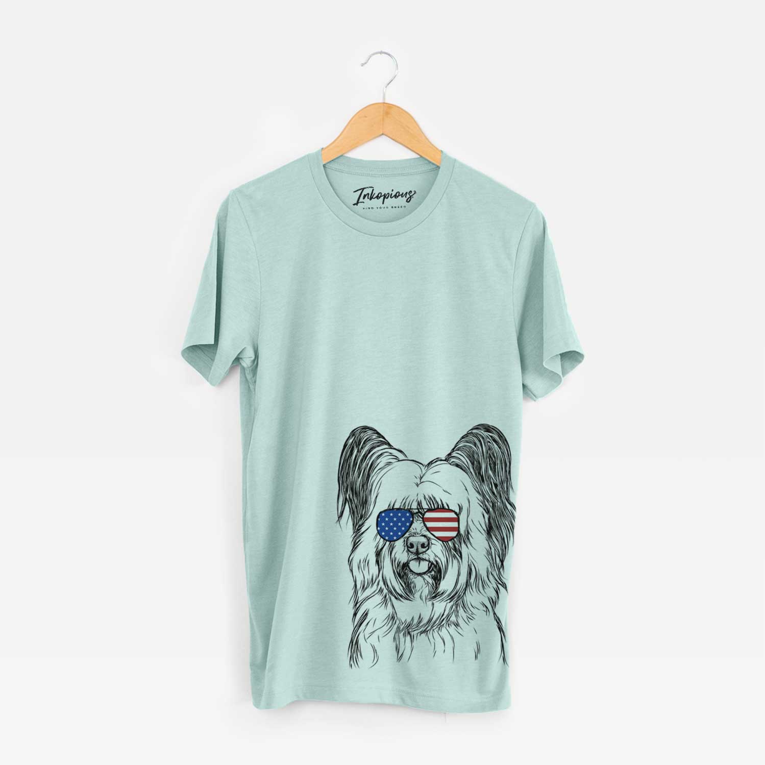 Hand-drawn sketch of Gideon the Skye Terrier wearing American flag sunglasses on a Heather Sage Unisex crewneck