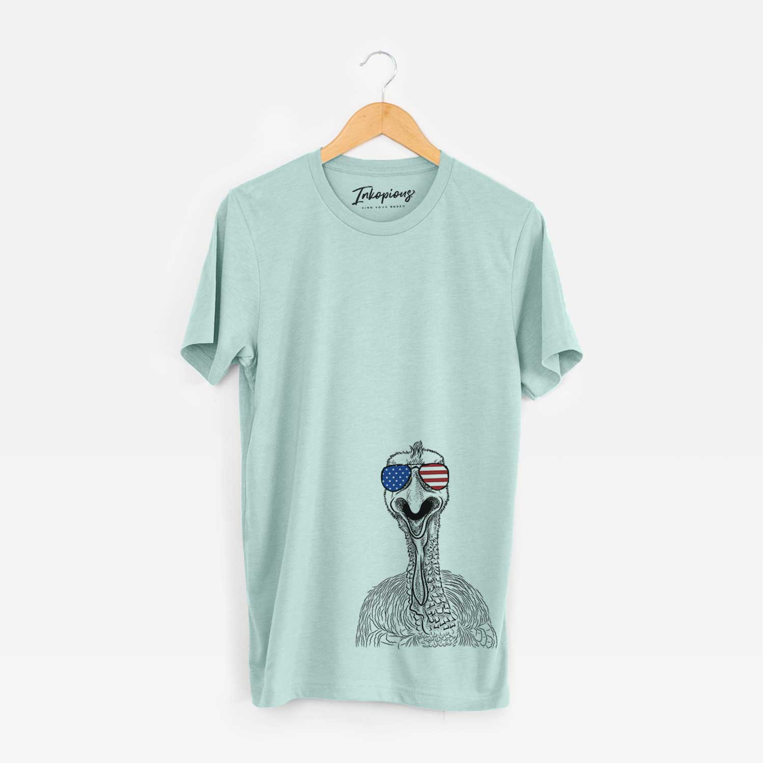 Hand-drawn sketch of Gobble the Turkey wearing American flag sunglasses on a Heather Sage Unisex crewneck