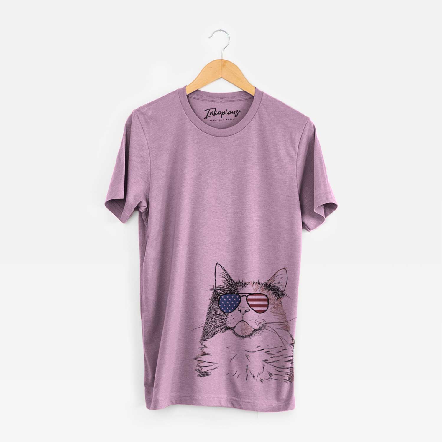 Hand-drawn sketch of Greta the Calico Cat wearing American flag sunglasses on an Orchid Unisex crewneck