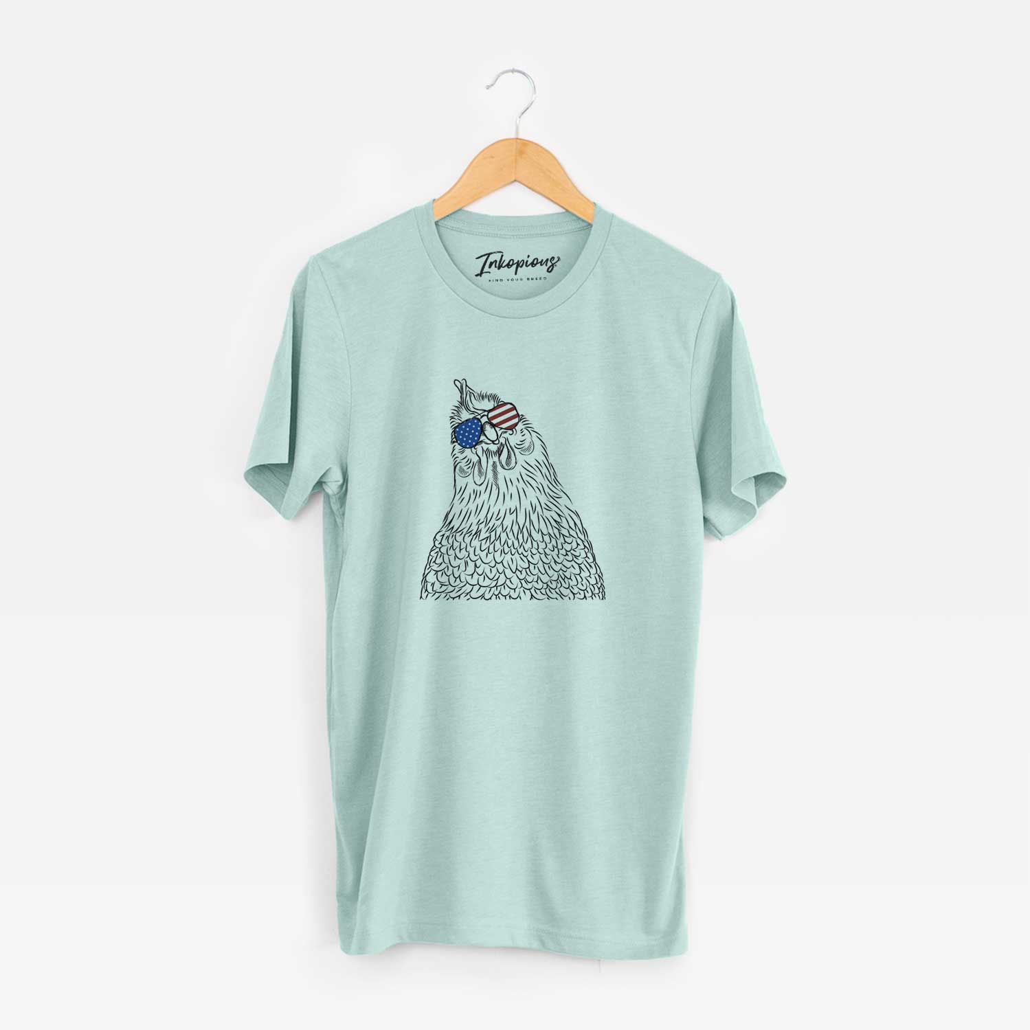 Hand-drawn sketch of Henrietta the Chicken wearing American flag sunglasses on a Heather Sage Unisex crewneck