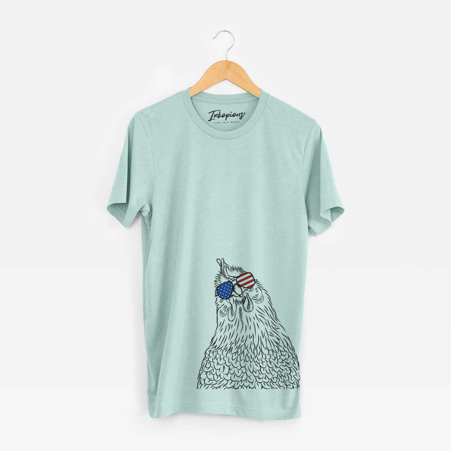 Hand-drawn sketch of Henrietta the Chicken wearing American flag sunglasses on a Heather Sage Unisex crewneck