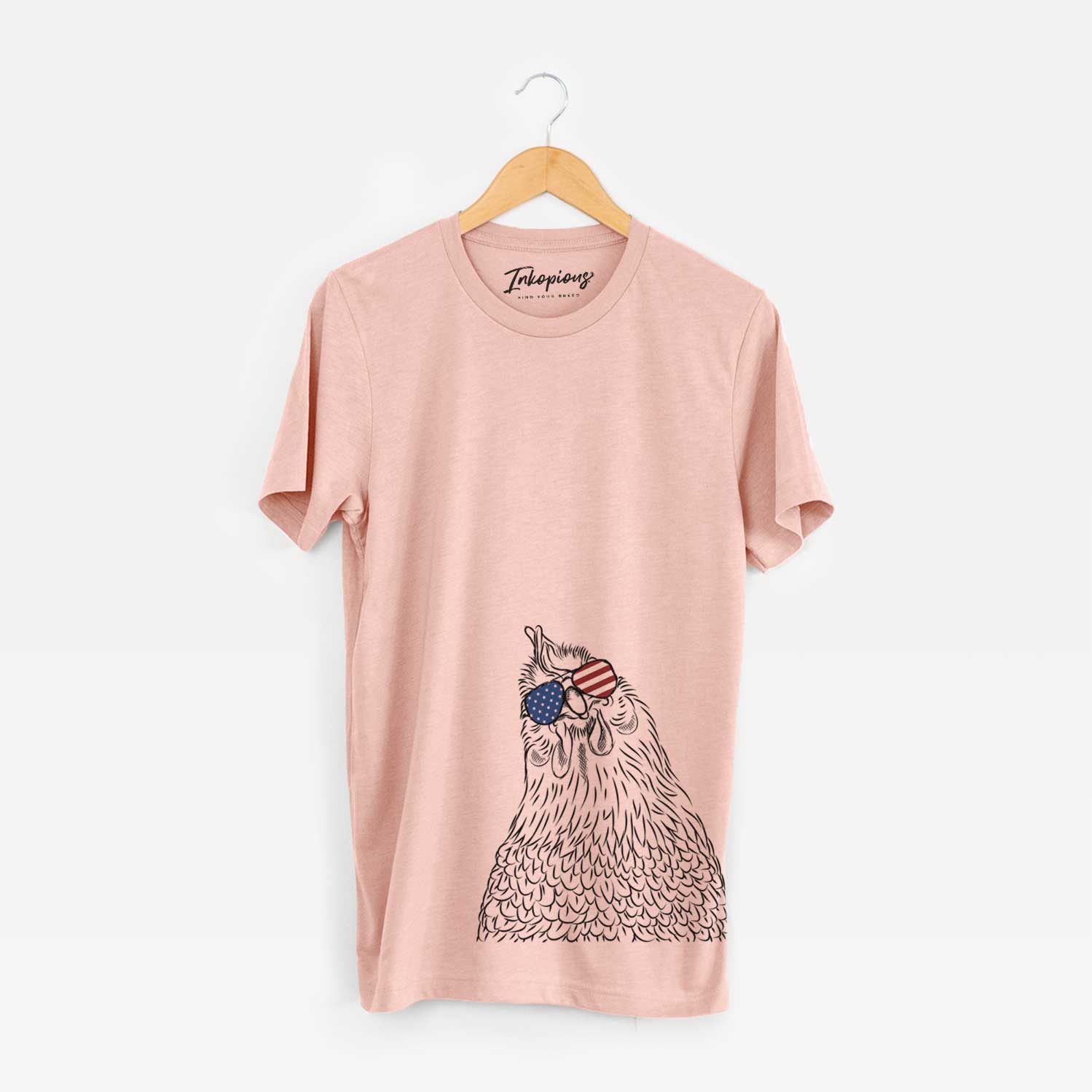 Hand-drawn sketch of Henrietta the Chicken wearing American flag sunglasses on a Peach Unisex crewneck