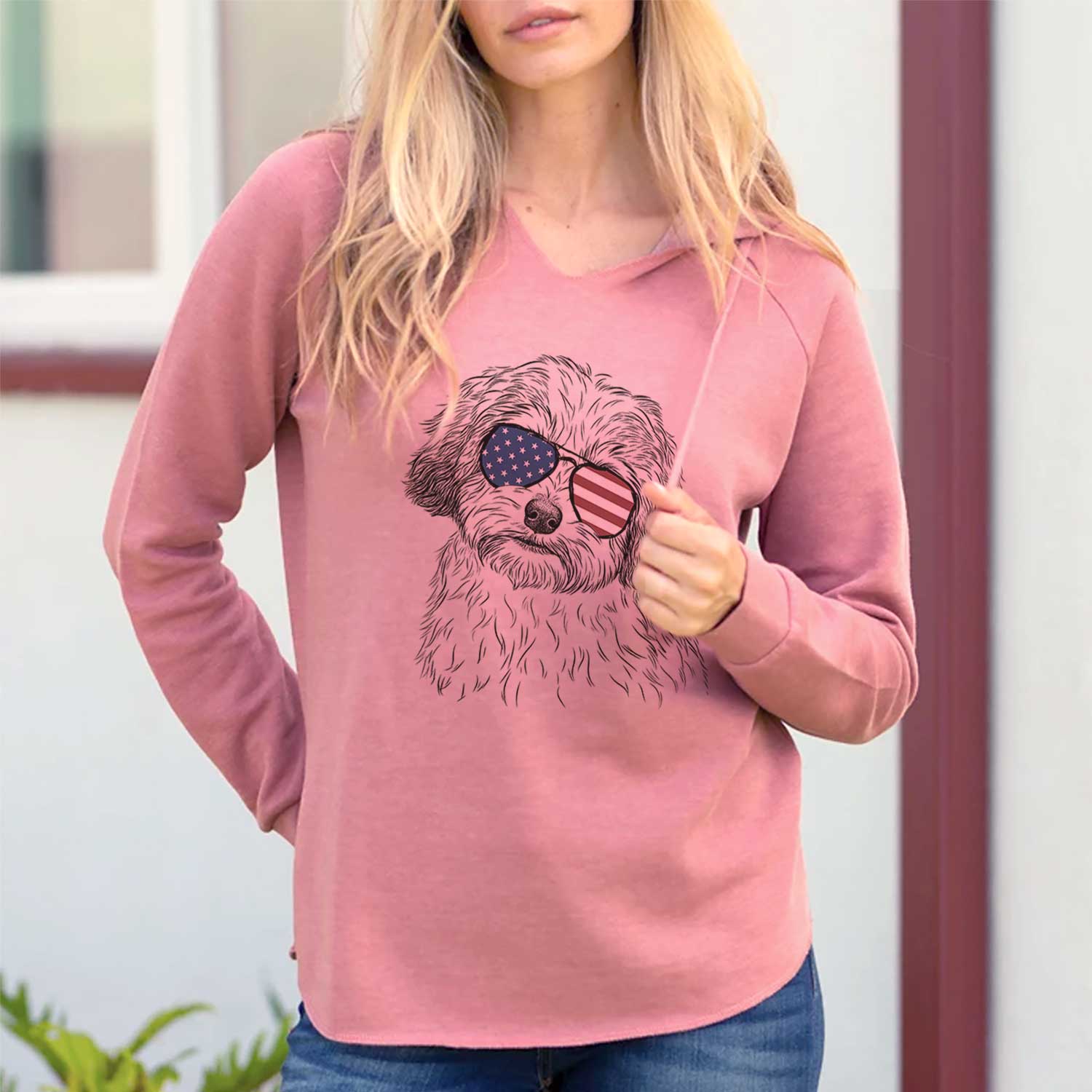 Hand-drawn sketch of Henry the Havanese wearing American flag sunglasses on a Dusty Rose Cali Wave Hooded Sweatshirt, lifestyle photo