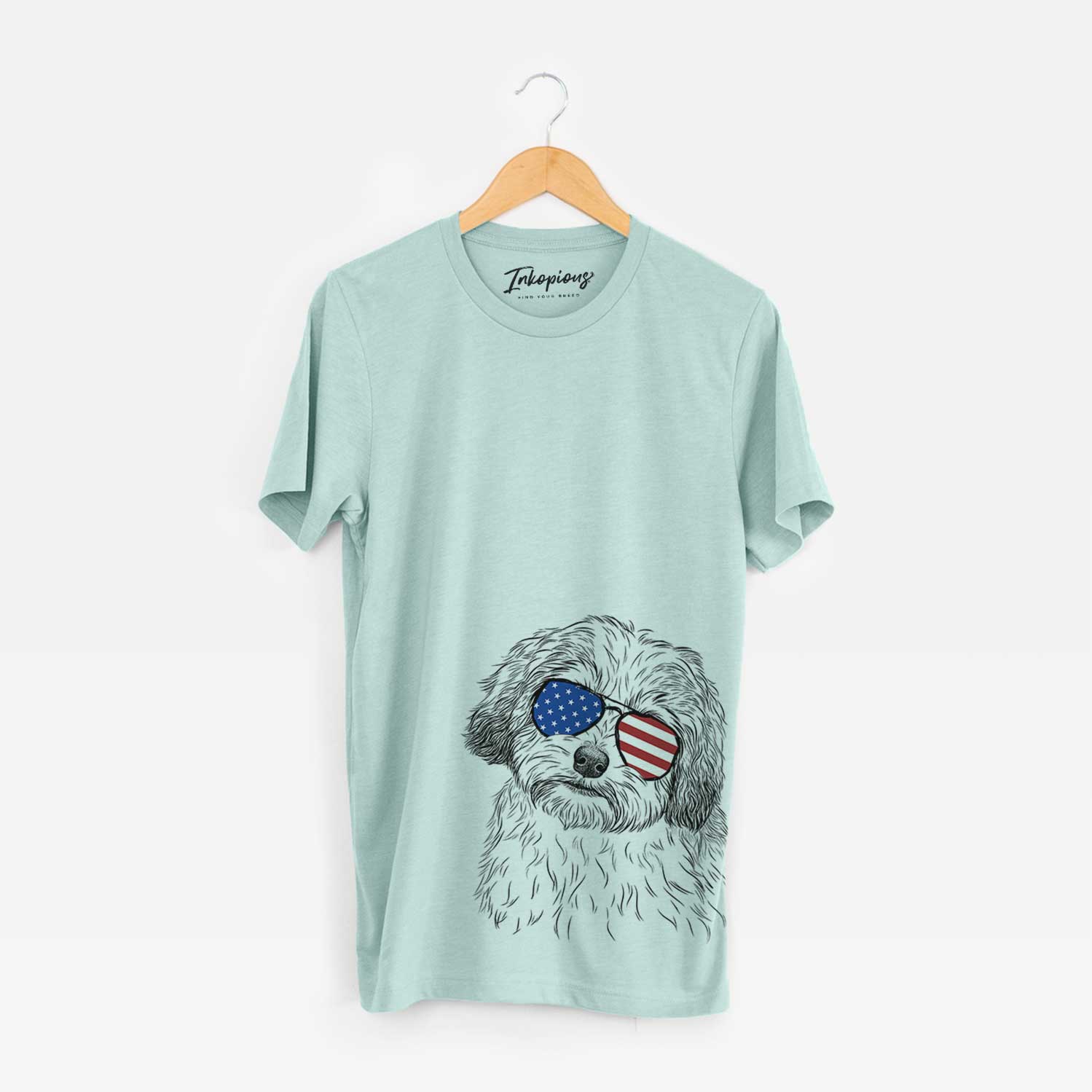 Hand-drawn sketch of Henry the Havanese wearing American flag sunglasses on a Heather Sage Unisex crewneck