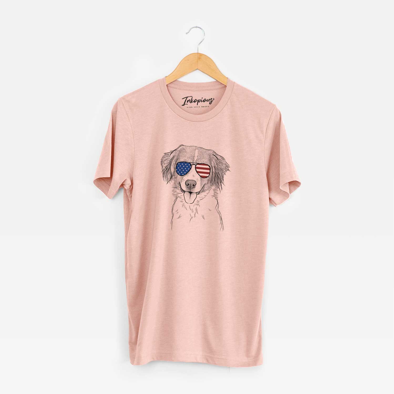 Hand-drawn sketch of Hercules the Nederlandse Kooikerhondje wearing American flag sunglasses on a Peach Unisex crewneck