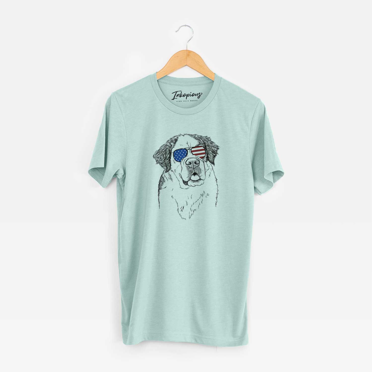 Hand-drawn sketch of Hook the Saint Bernard wearing American flag sunglasses on a Heather Sage Unisex crewneck