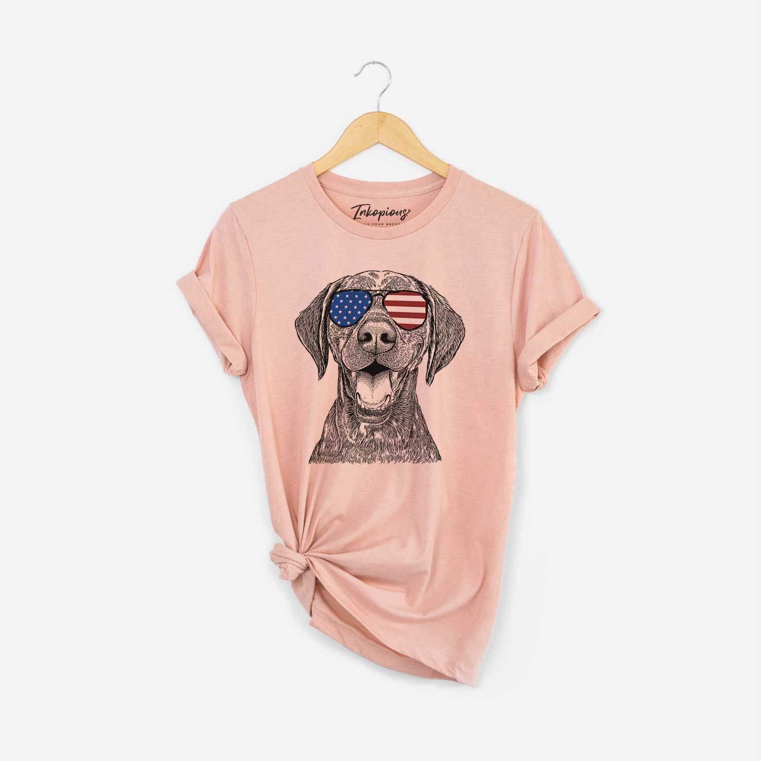 Hand-drawn sketch of Hudson the German Shorthaired Pointer wearing American flag sunglasses on a Peach Unisex crewneck