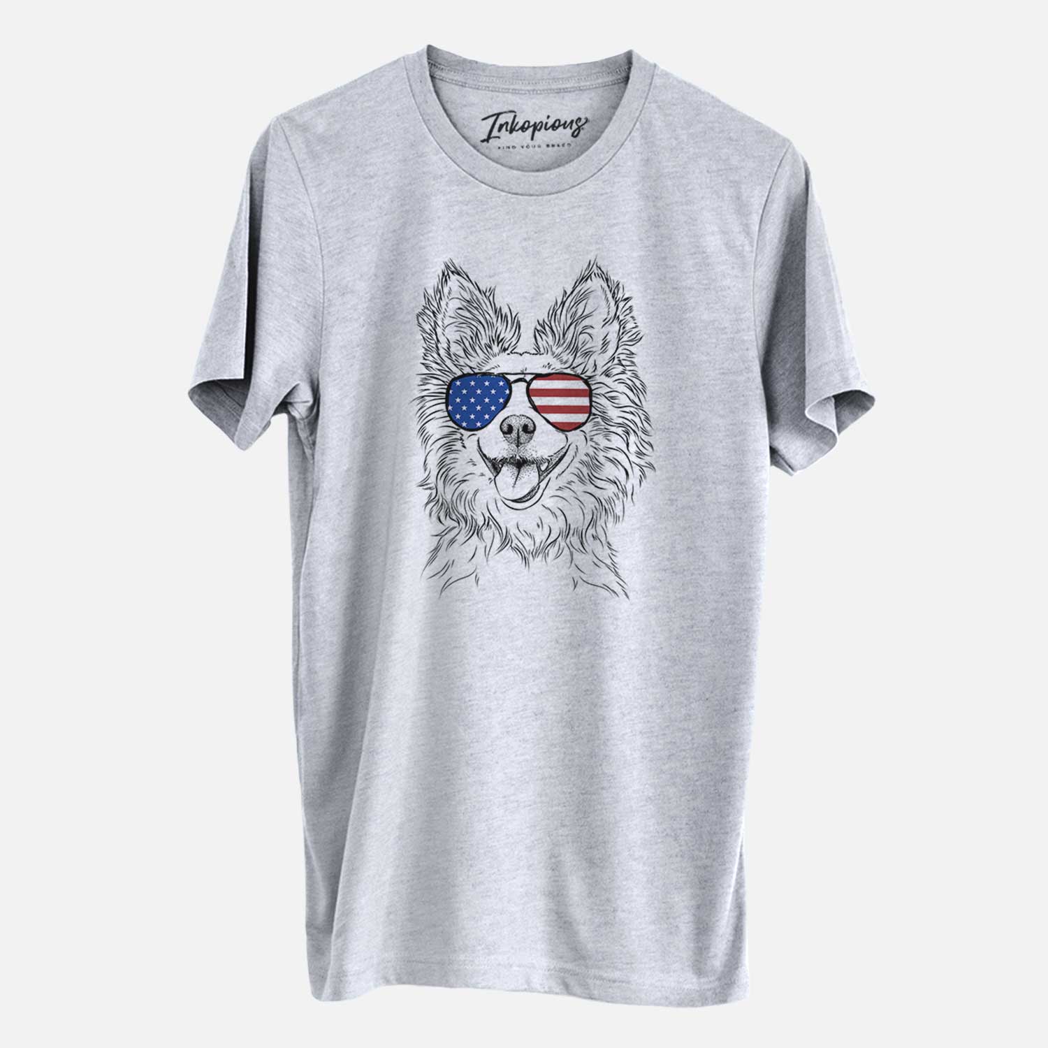 Hand-drawn sketch of Jasper the Pomchi wearing American flag sunglasses on a Grey Unisex crewneck