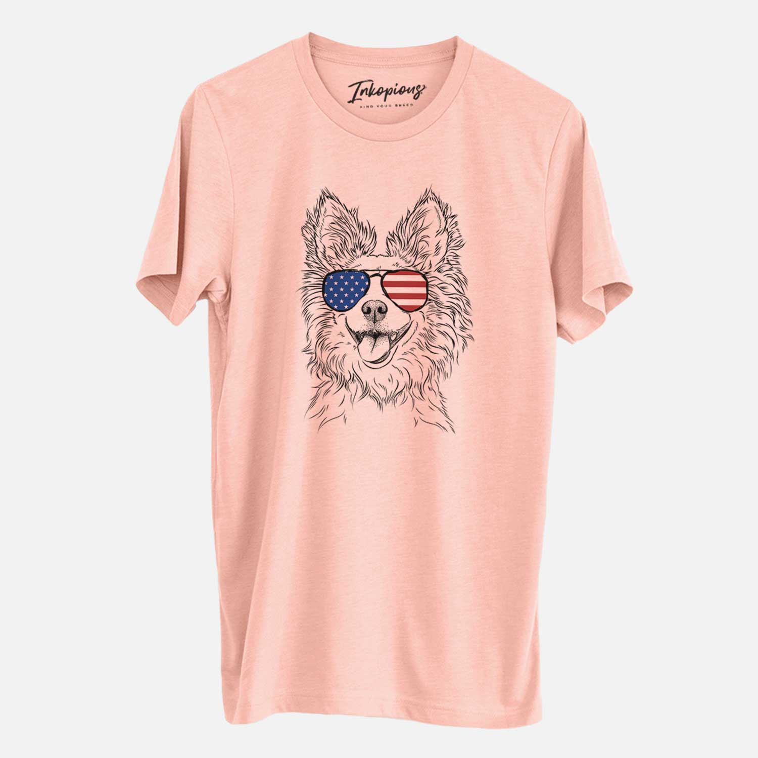 Hand-drawn sketch of Jasper the Pomchi wearing American flag sunglasses on a Peach Unisex crewneck