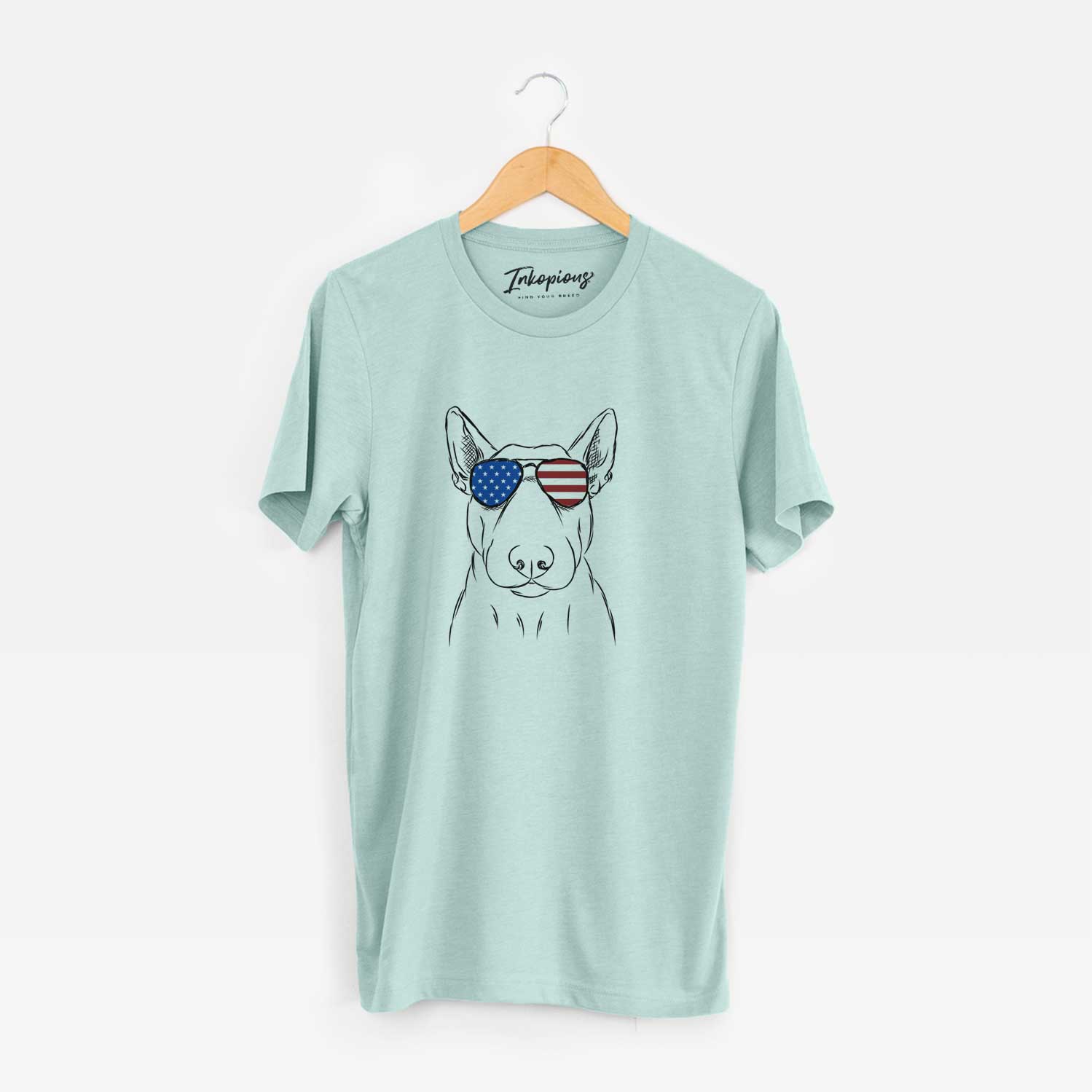 Hand-drawn sketch of Jett the Bull Terrier wearing American flag sunglasses on a Heather Sage Unisex crewneck
