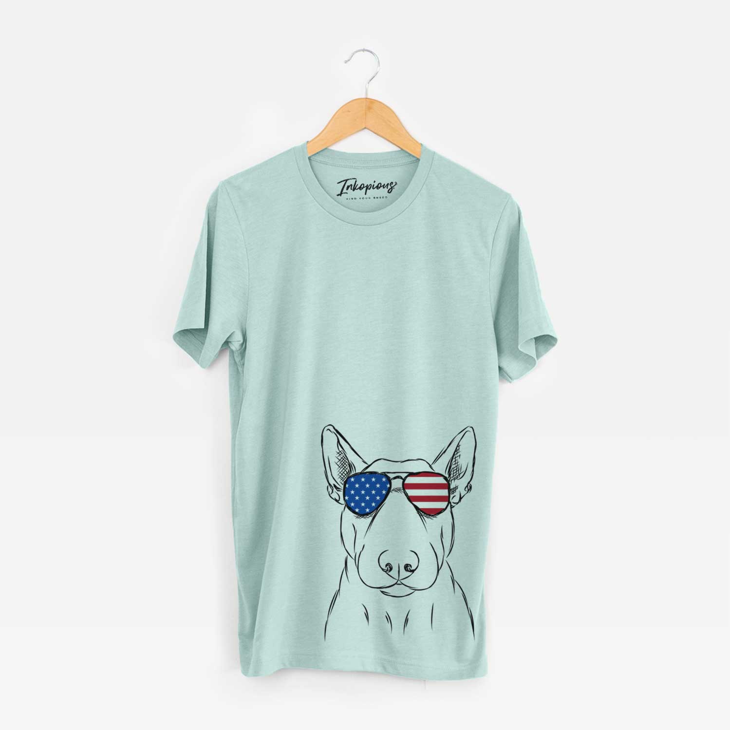 Hand-drawn sketch of Jett the Bull Terrier wearing American flag sunglasses on a Heather Sage Unisex crewneck