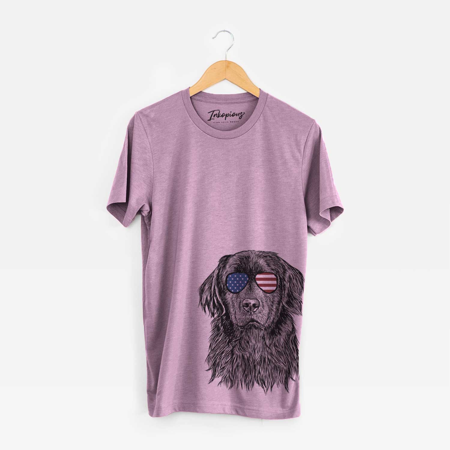 Hand-drawn sketch of Jinx the Newfoundland wearing American flag sunglasses on an Orchid Unisex crewneck