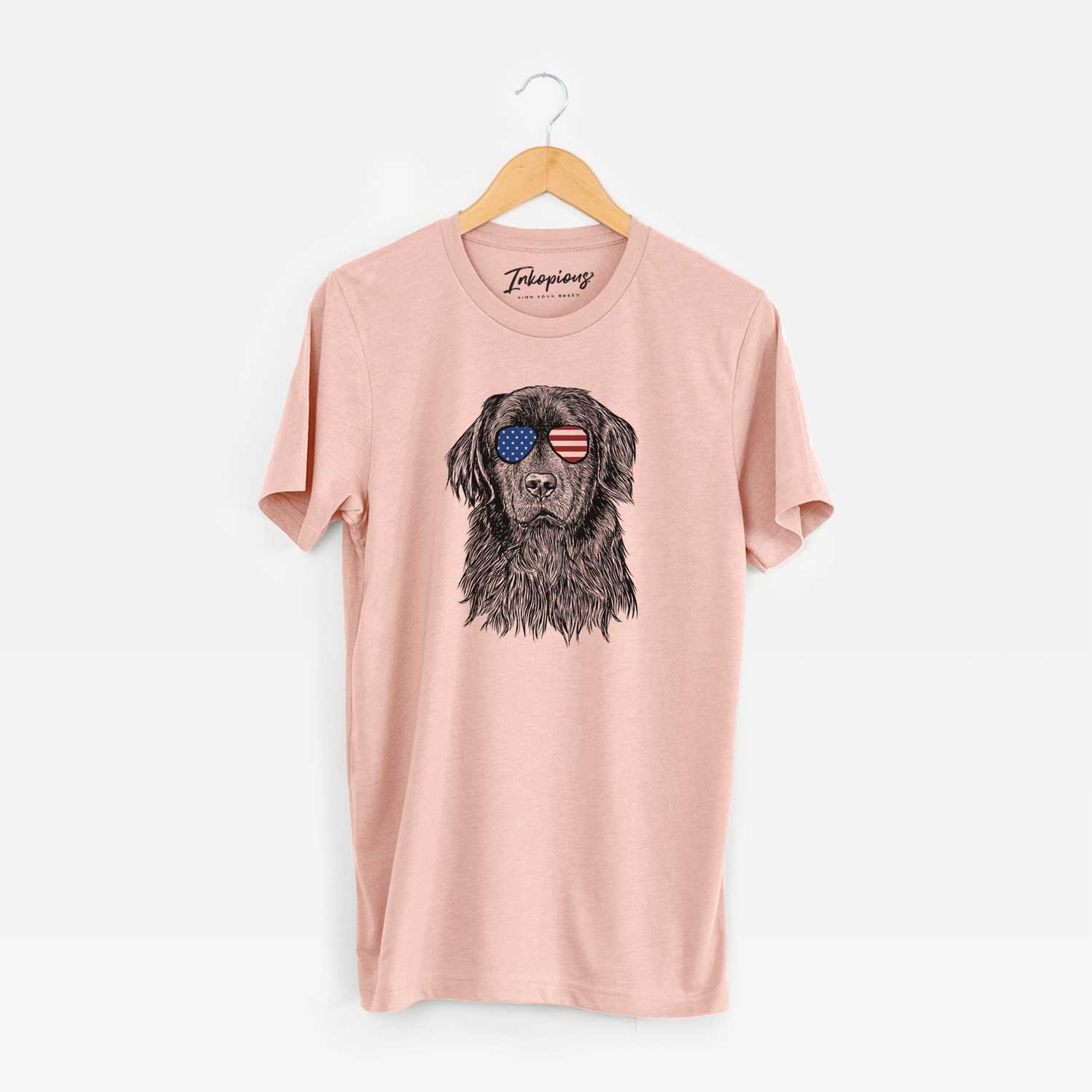Hand-drawn sketch of Jinx the Newfoundland wearing American flag sunglasses on a Peach Unisex crewneck