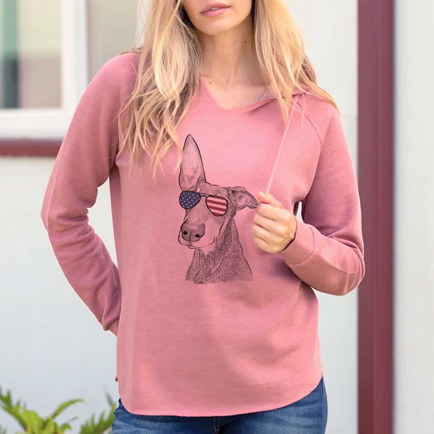 Hand-drawn sketch of Kain the Doberman Pinscher wearing American flag sunglasses on a Dusty Rose Cali Wave Hooded Sweatshirt, lifestyle photo