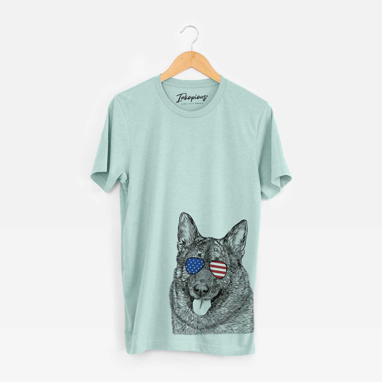 Hand-drawn sketch of Kasia the Norwegian Elkhound wearing American flag sunglasses on a Heather Sage Unisex crewneck