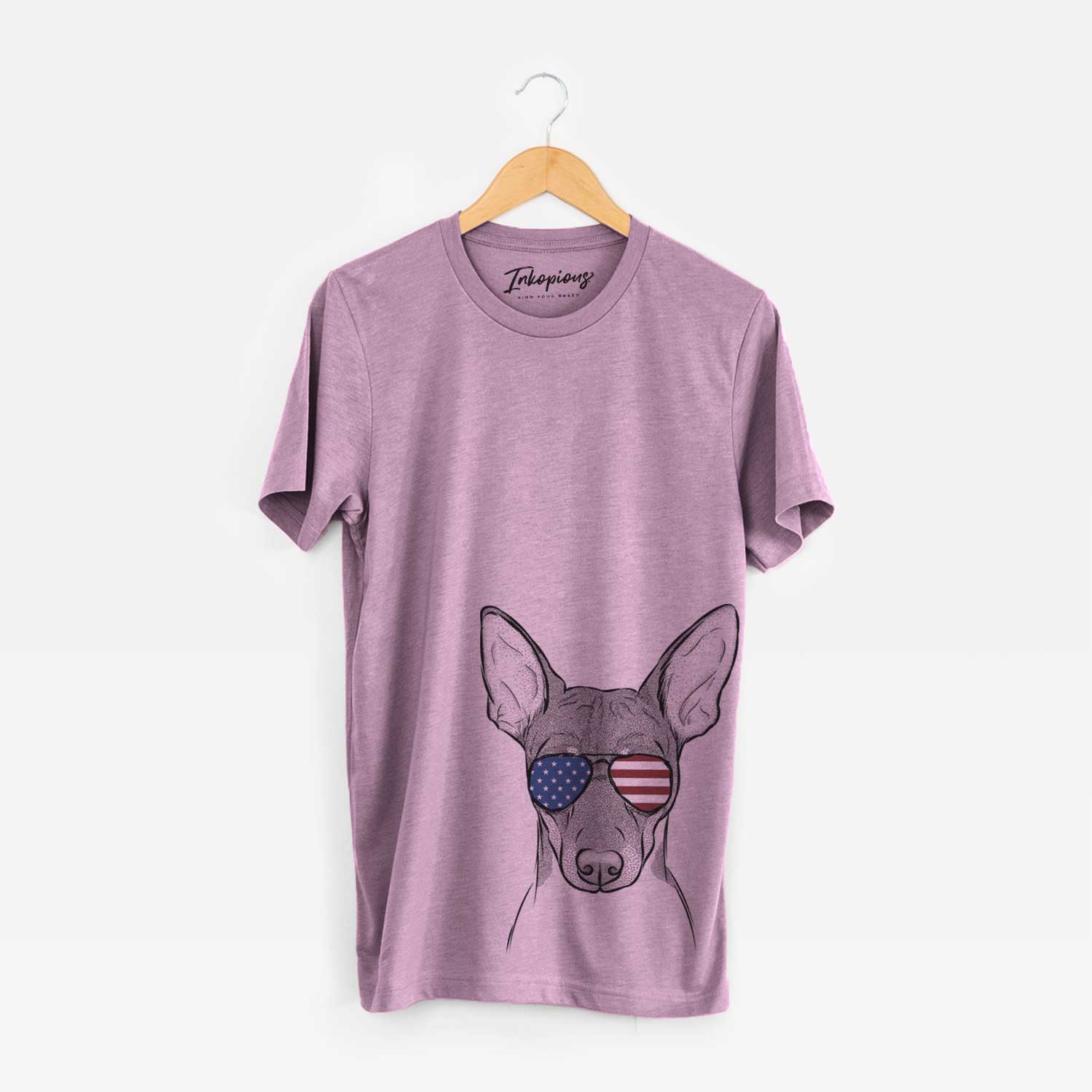 Hand-drawn sketch of Knox the Rat Terrier wearing American flag sunglasses on an Orchid Unisex crewneck