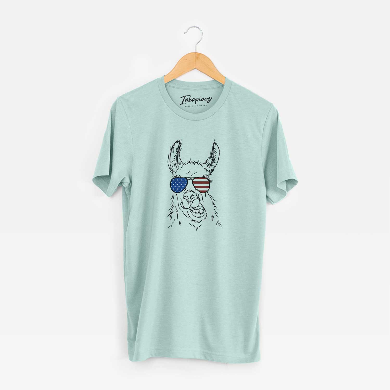 Hand-drawn sketch of Larry the Llama wearing American flag sunglasses on a Heather Sage Unisex crewneck