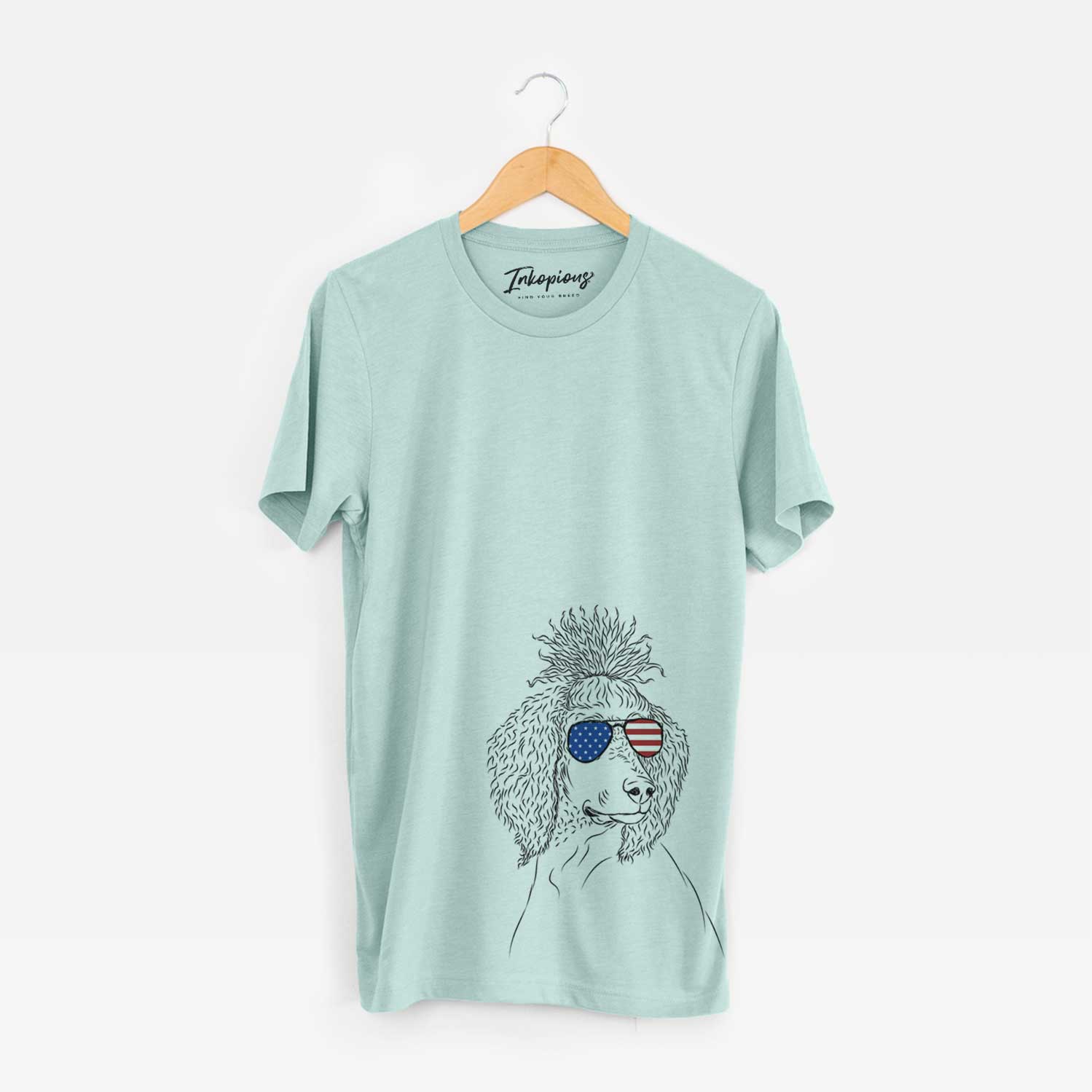 Hand-drawn sketch of Leo the Poodle wearing American flag sunglasses on a Heather Sage Unisex crewneck