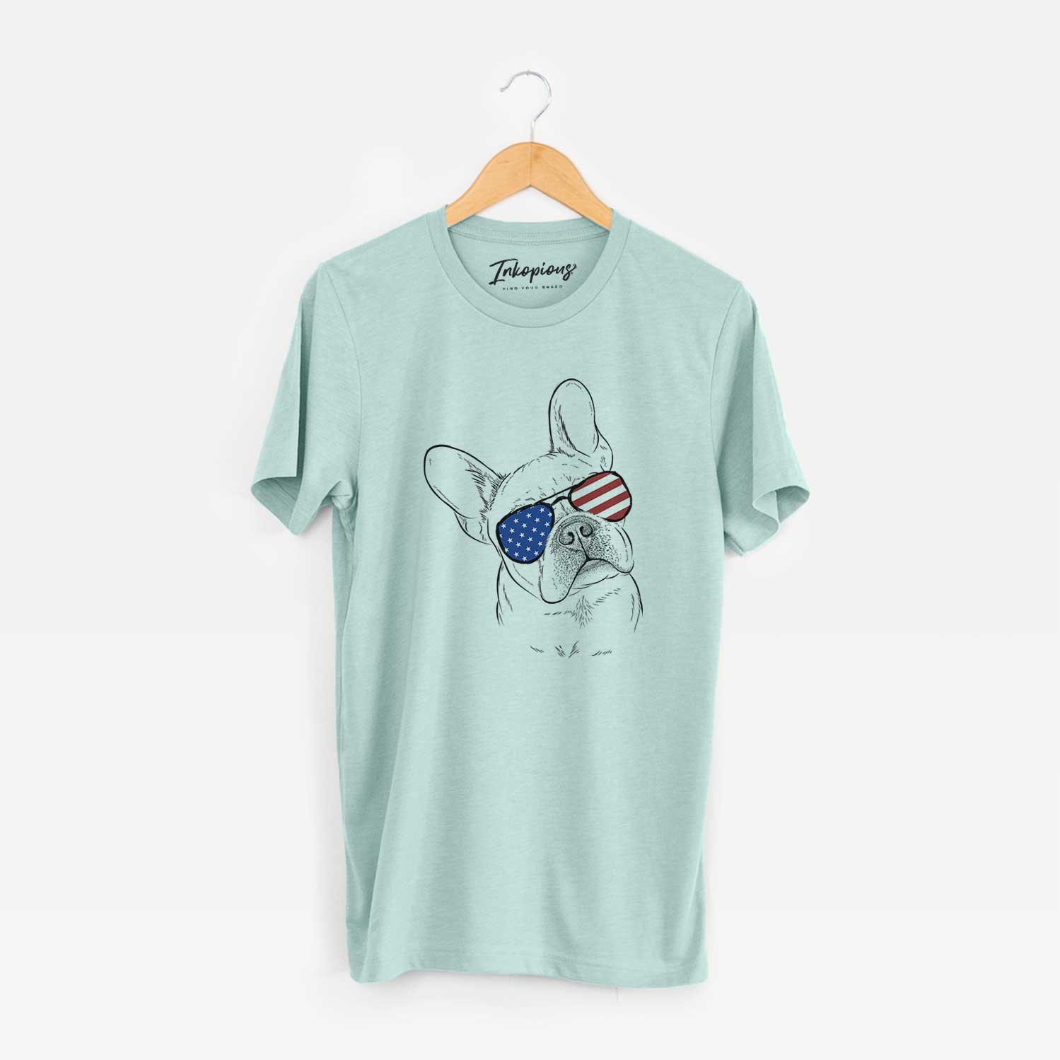 Hand-drawn sketch of Loki the French Bulldog wearing American flag sunglasses on a Heather Sage Unisex crewneck