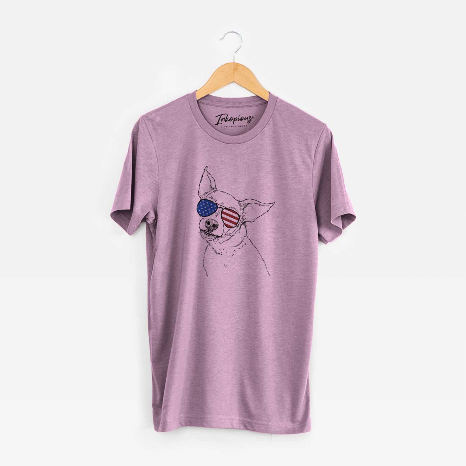Hand-drawn sketch of Lola the Chiweenie wearing American flag sunglasses on an Orchid Unisex crewneck