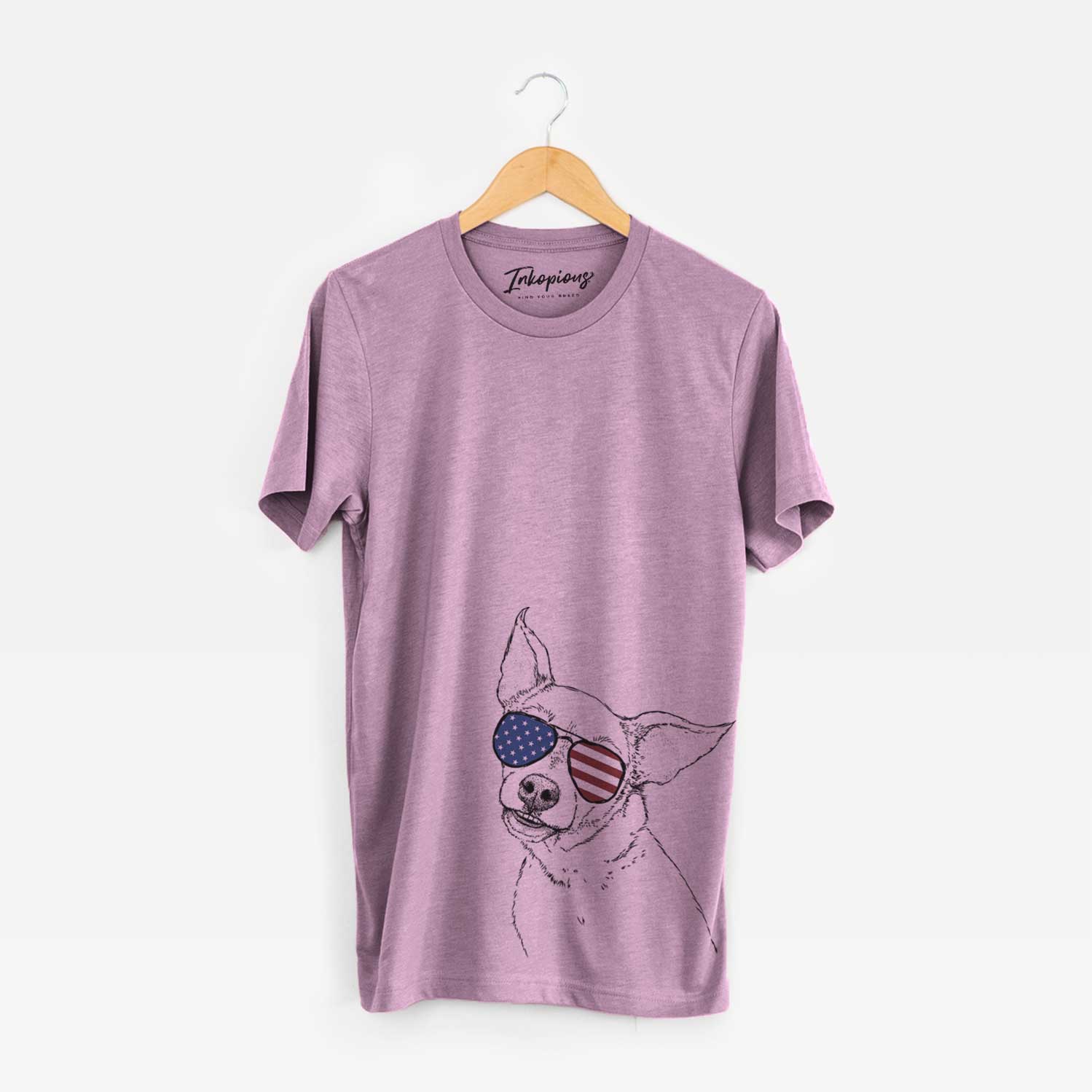 Hand-drawn sketch of Lola the Chiweenie wearing American flag sunglasses on an Orchid Unisex crewneck
