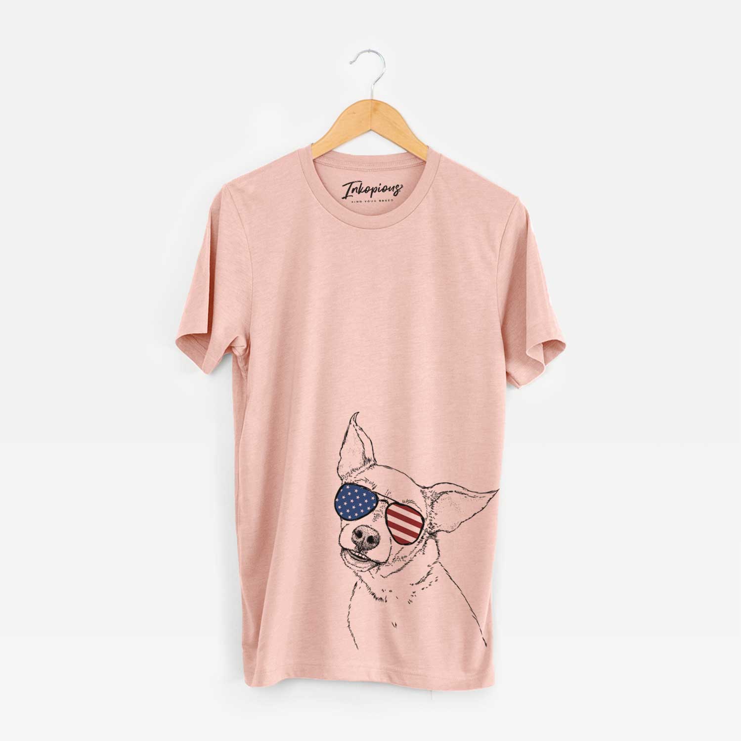 Hand-drawn sketch of Lola the Chiweenie wearing American flag sunglasses on a Peach Unisex crewneck
