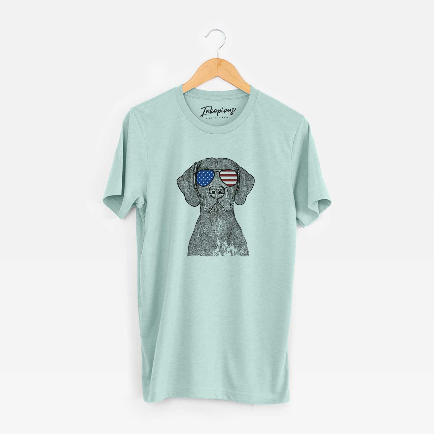 Hand-drawn sketch of Lucifer the German Shorthaired Pointer wearing American flag sunglasses on a Heather Sage Unisex crewneck