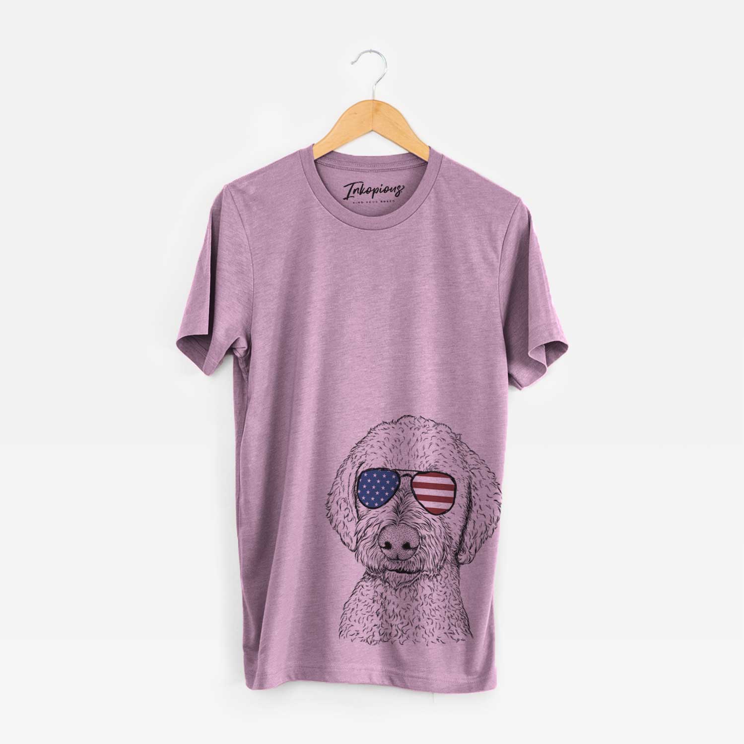 Hand-drawn sketch of Lucy Boo the Goldendoodle wearing American flag sunglasses on an Orchid Unisex crewneck