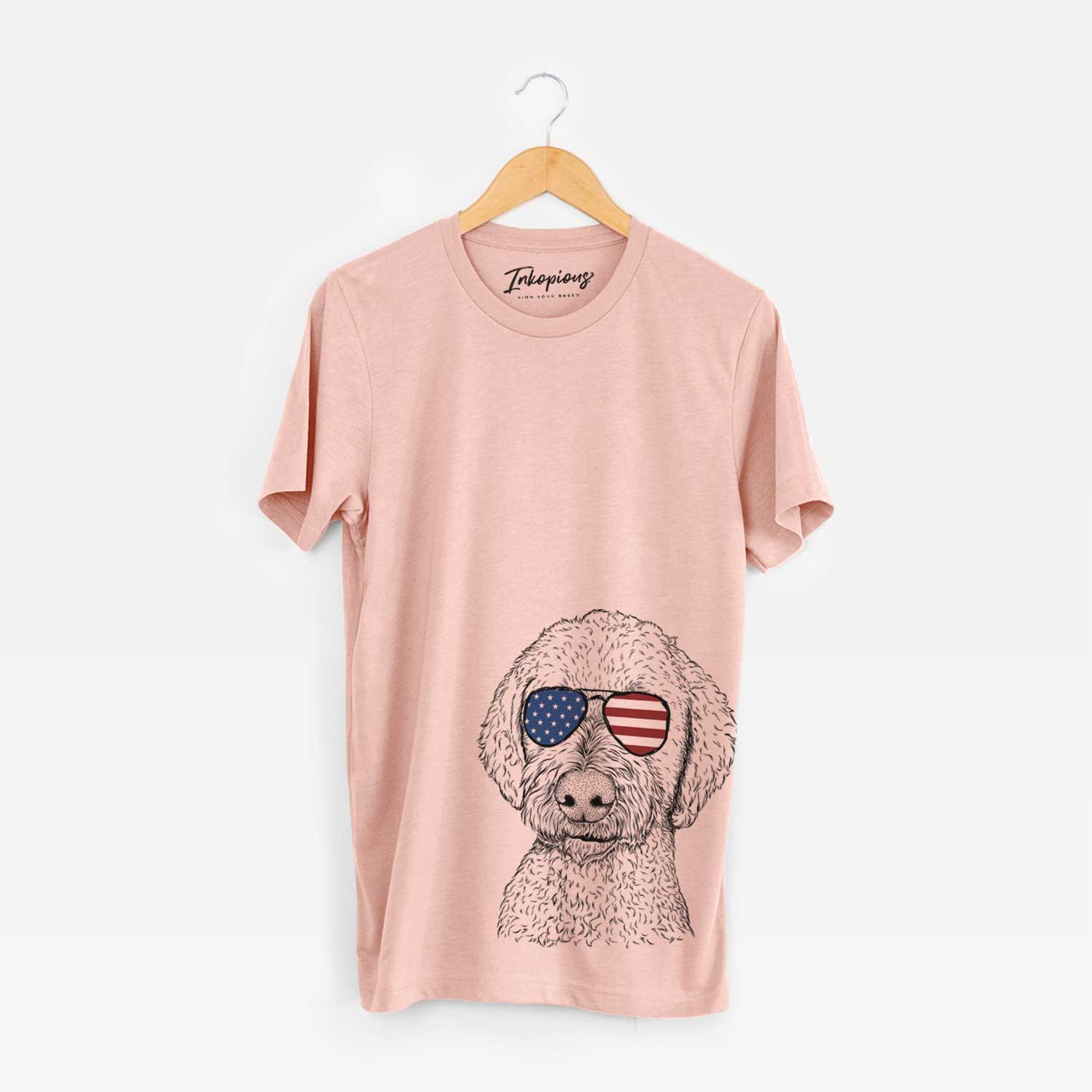 Hand-drawn sketch of Lucy Boo the Goldendoodle wearing American flag sunglasses on a Peach Unisex crewneck