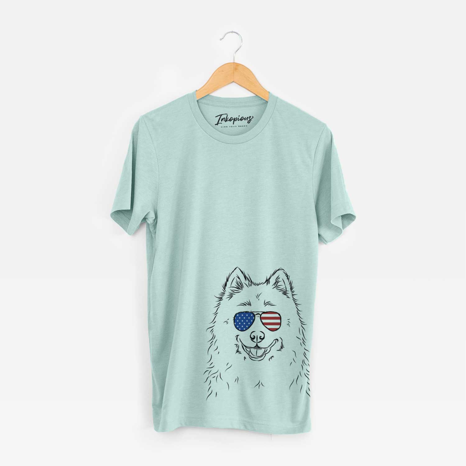 Hand-drawn sketch of Luka the Samoyed wearing American flag sunglasses on a Heather Sage Unisex crewneck