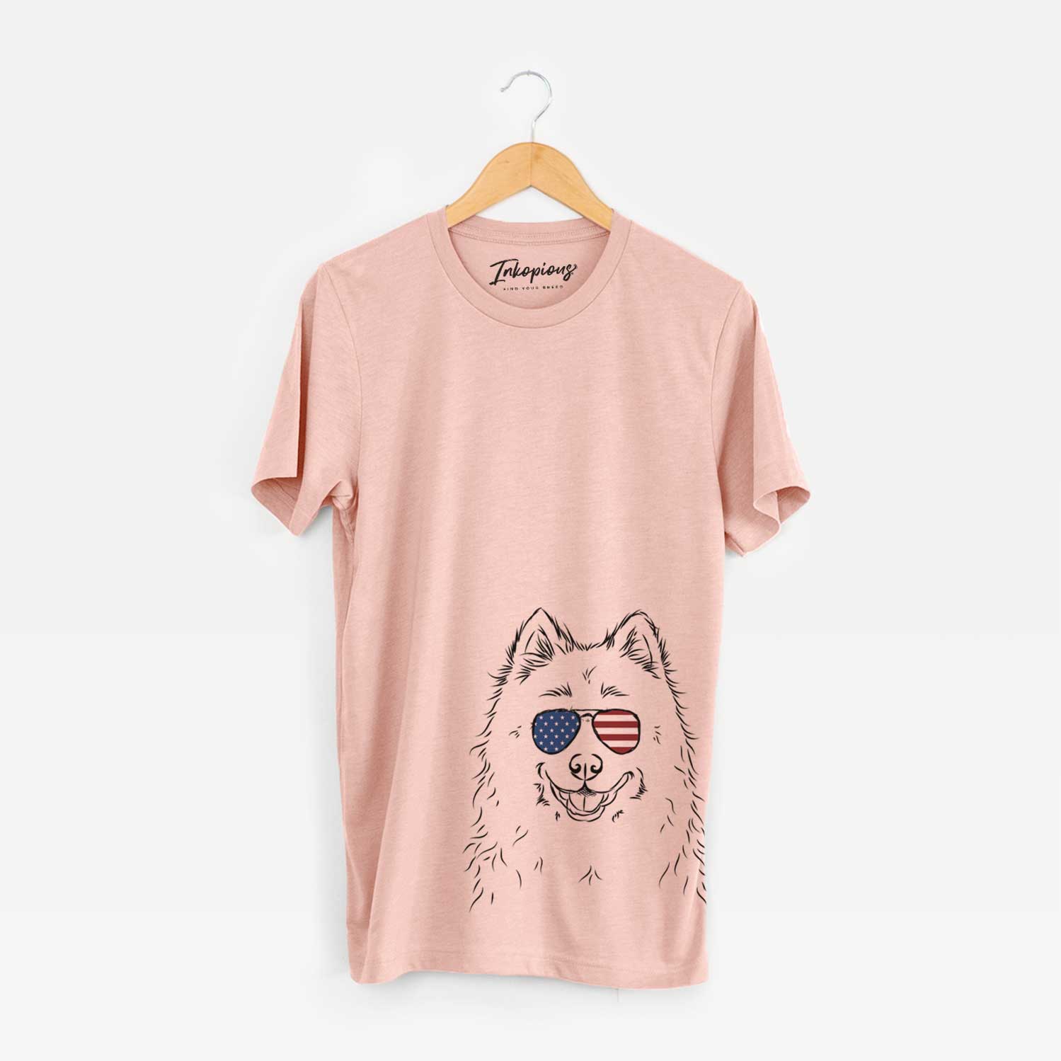 Hand-drawn sketch of Luka the Samoyed wearing American flag sunglasses on a Peach Unisex crewneck