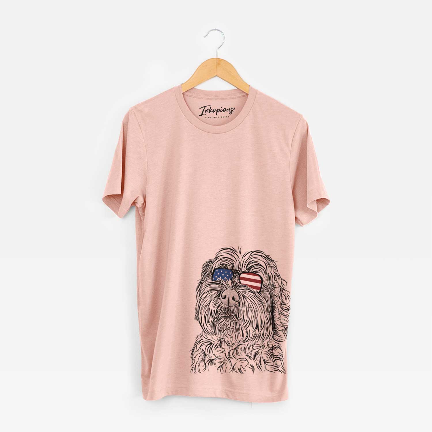 Hand-drawn sketch of Maggie Girl the Cockapoo wearing American flag sunglasses on a Peach Unisex crewneck