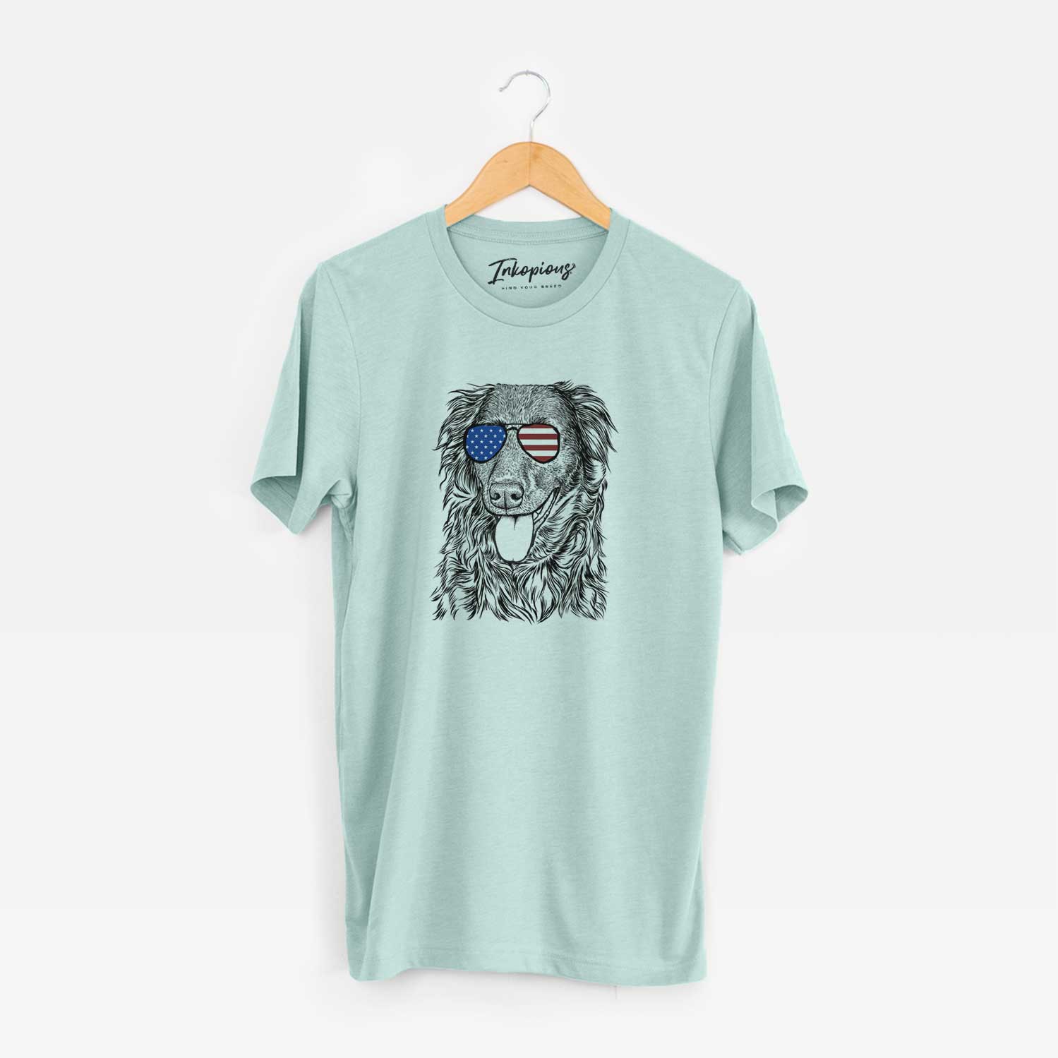 Hand-drawn sketch of Maisie Mae the Aussiedor wearing American flag sunglasses on a Heather Sage Unisex crewneck