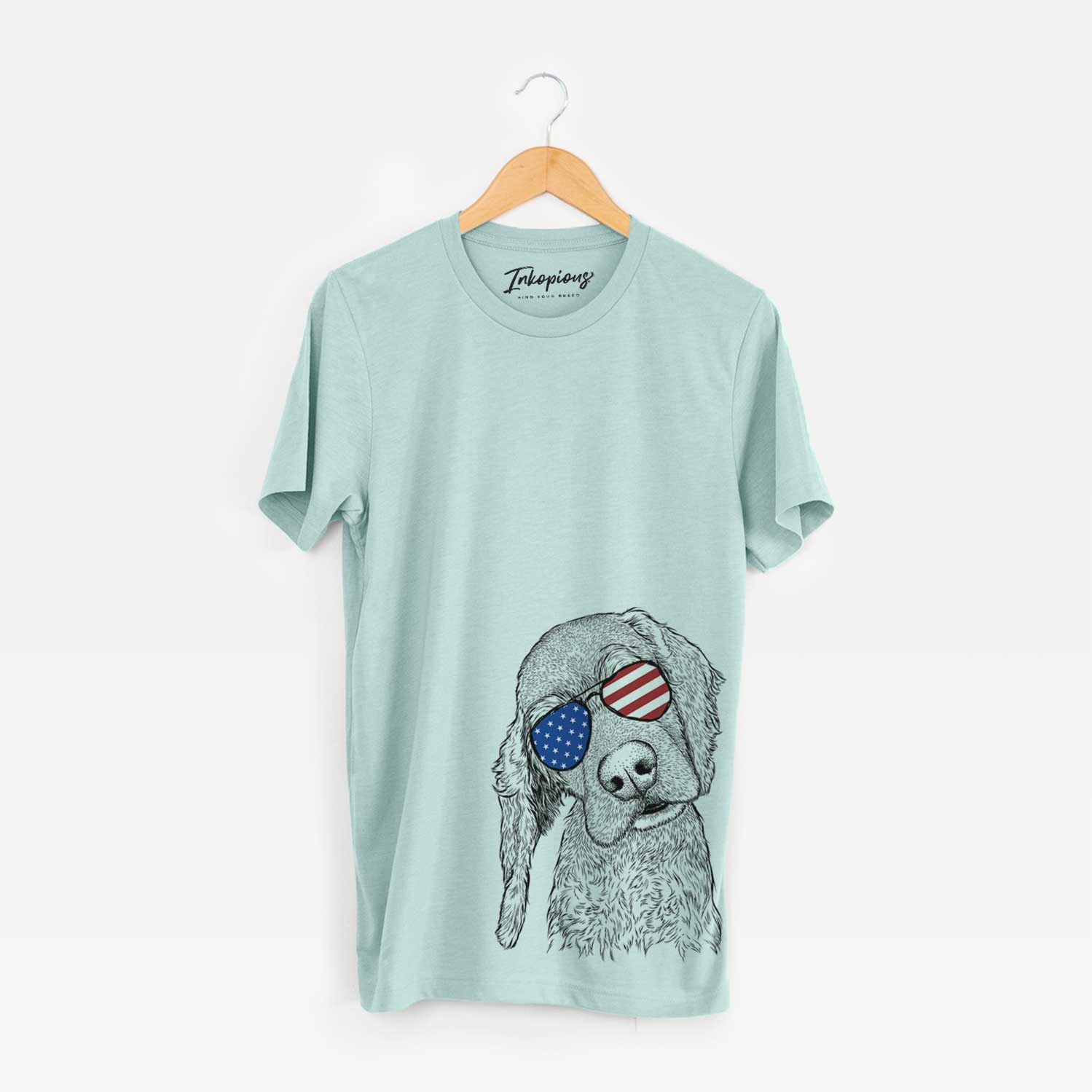 Hand-drawn sketch of Mambo #5 the Cocker Spaniel wearing American flag sunglasses on a Heather Sage Unisex crewneck