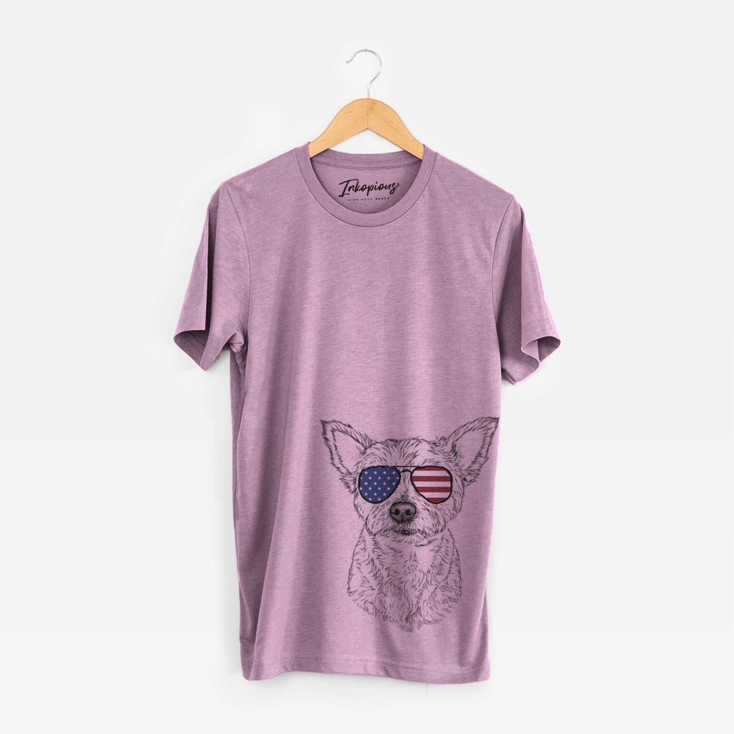 Hand-drawn sketch of Mango the Yorker Cairn Terrier Mix wearing American flag sunglasses on an Orchid Unisex crewneck