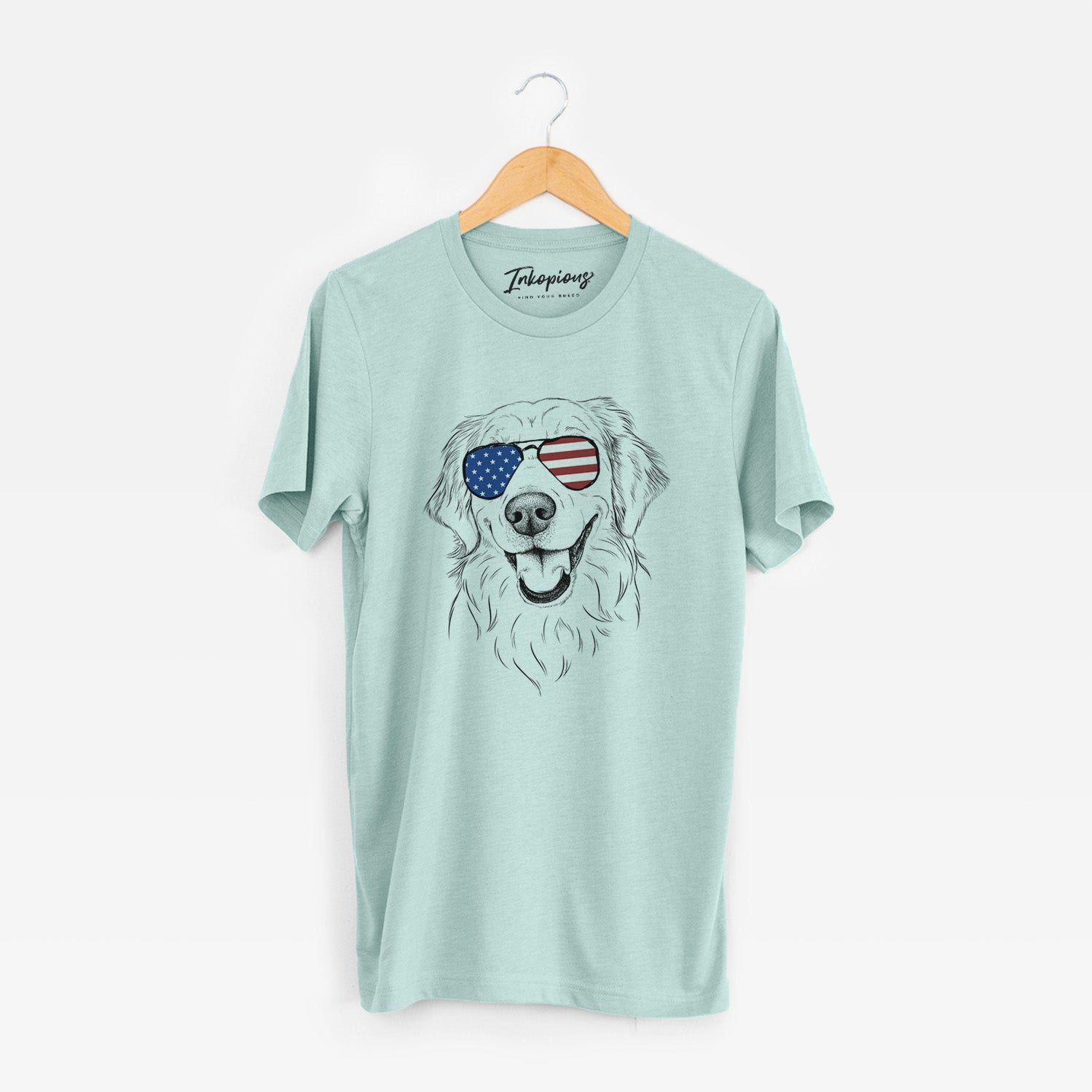 Hand-drawn sketch of Maple the Golden Retriever wearing American flag sunglasses on a Heather Sage Unisex crewneck