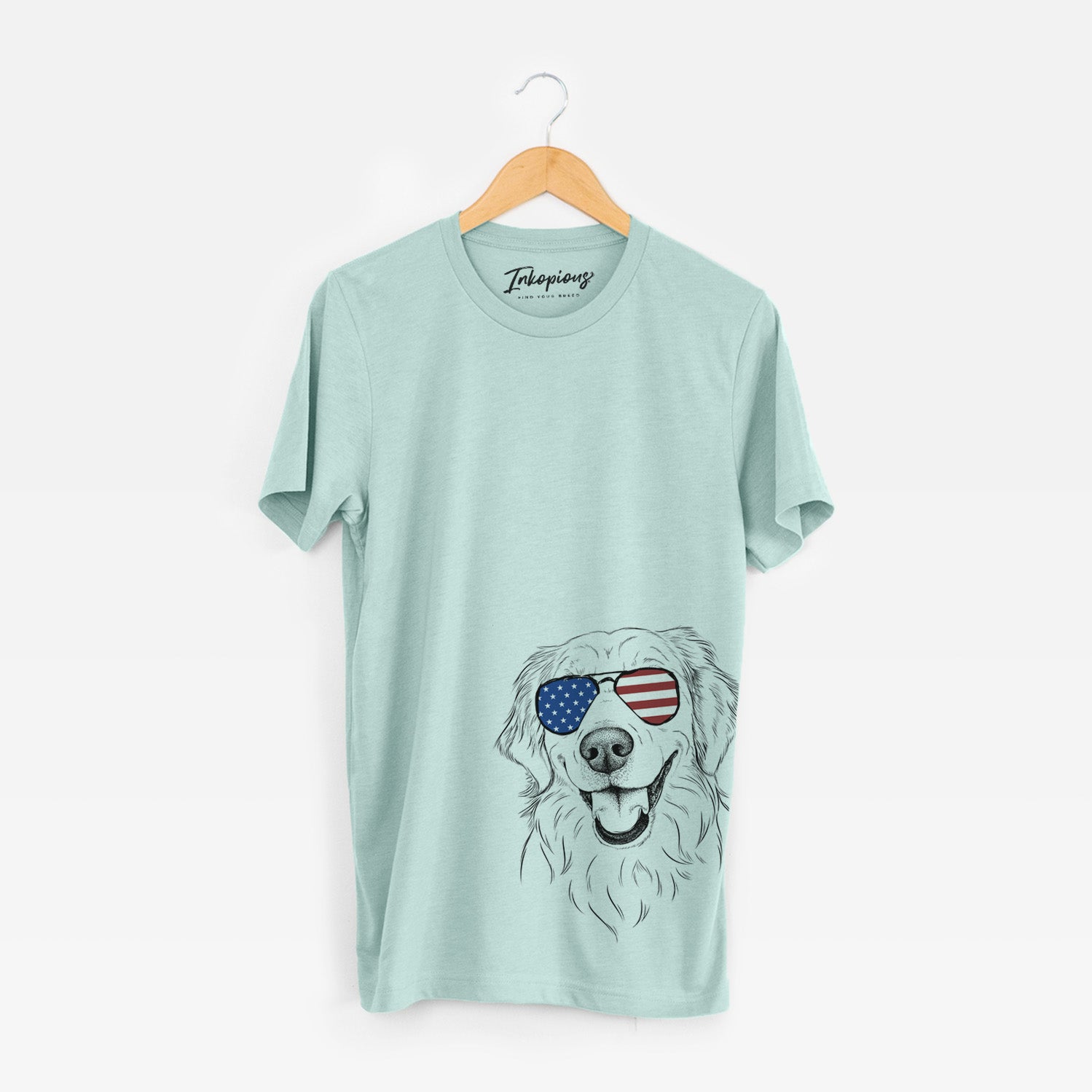 Hand-drawn sketch of Maple the Golden Retriever wearing American flag sunglasses on a Heather Sage Unisex crewneck