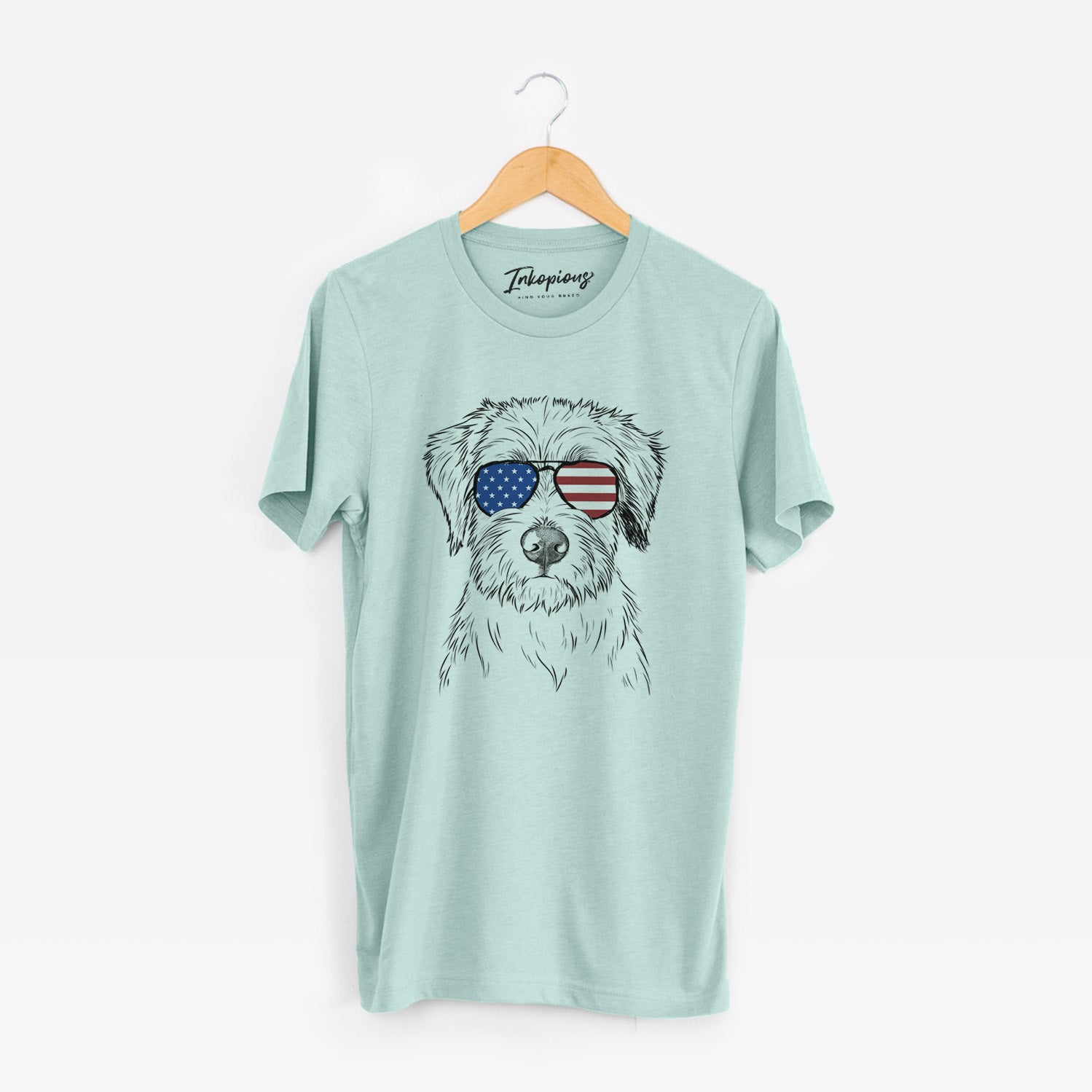 Hand-drawn sketch of Marek the Bernedoodle wearing American flag sunglasses on a Heather Sage Unisex crewneck