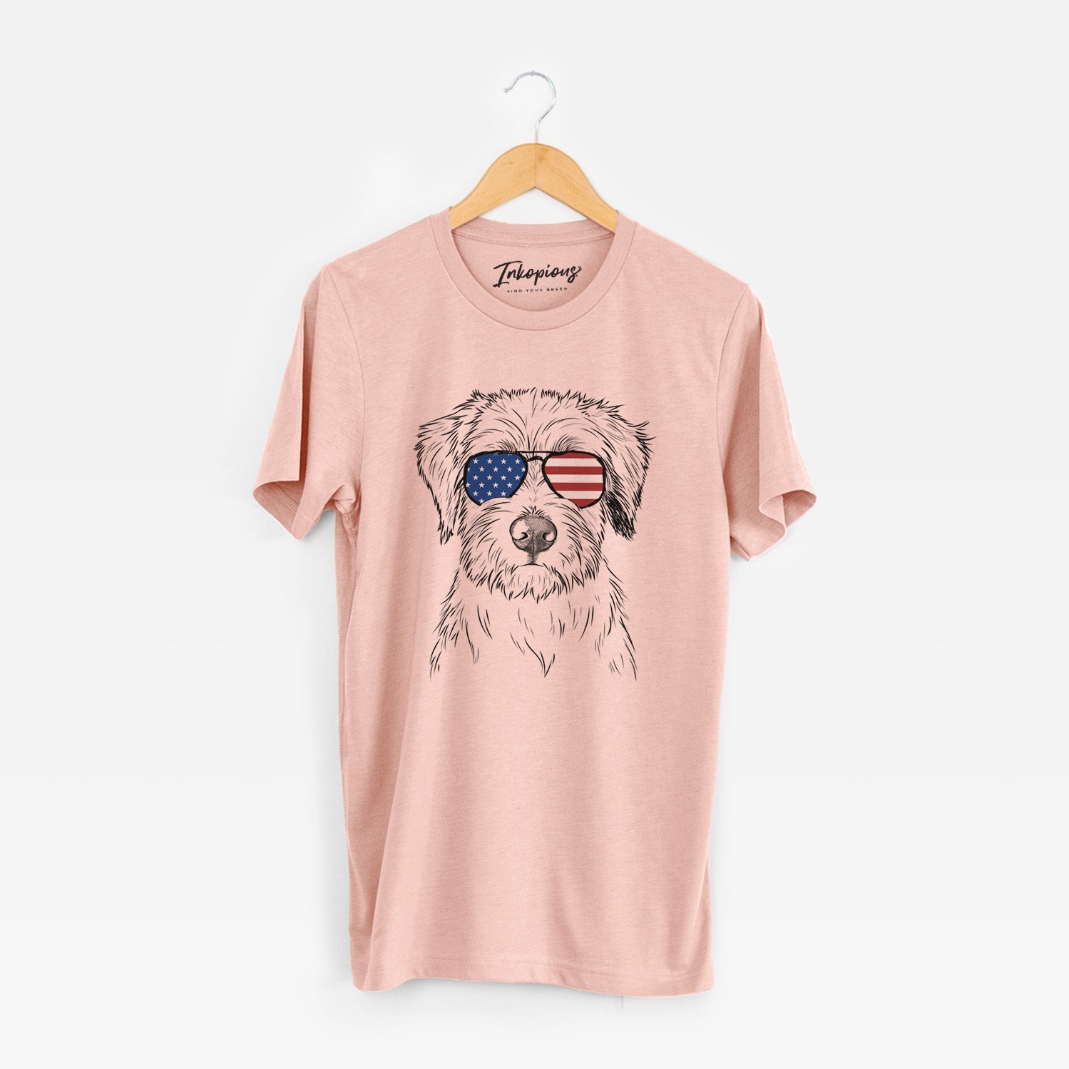 Hand-drawn sketch of Marek the Bernedoodle wearing American flag sunglasses on a Peach Unisex crewneck