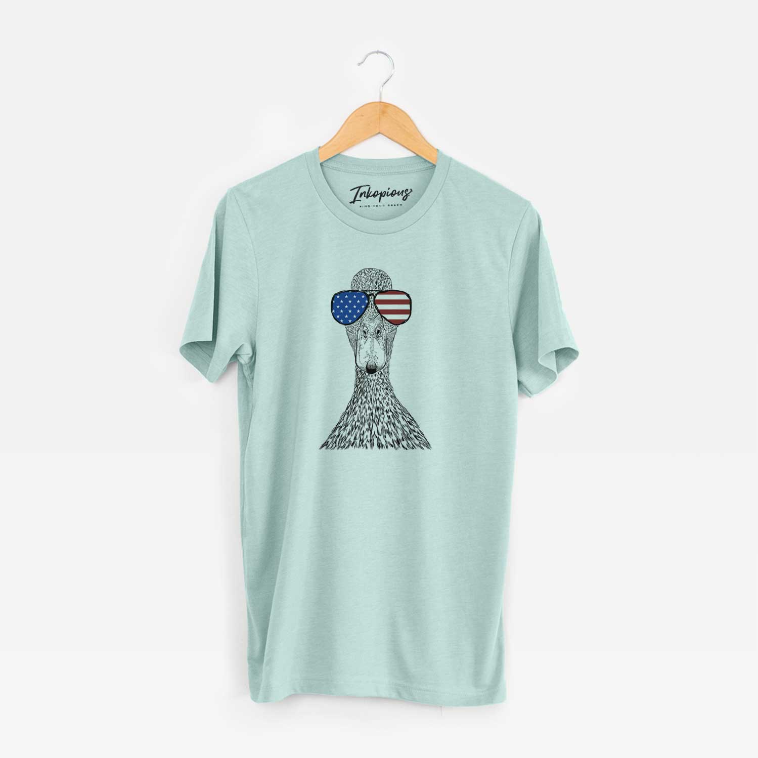 Hand-drawn sketch of Marge the Mallard Duck wearing American flag sunglasses on a Heather Sage Unisex crewneck
