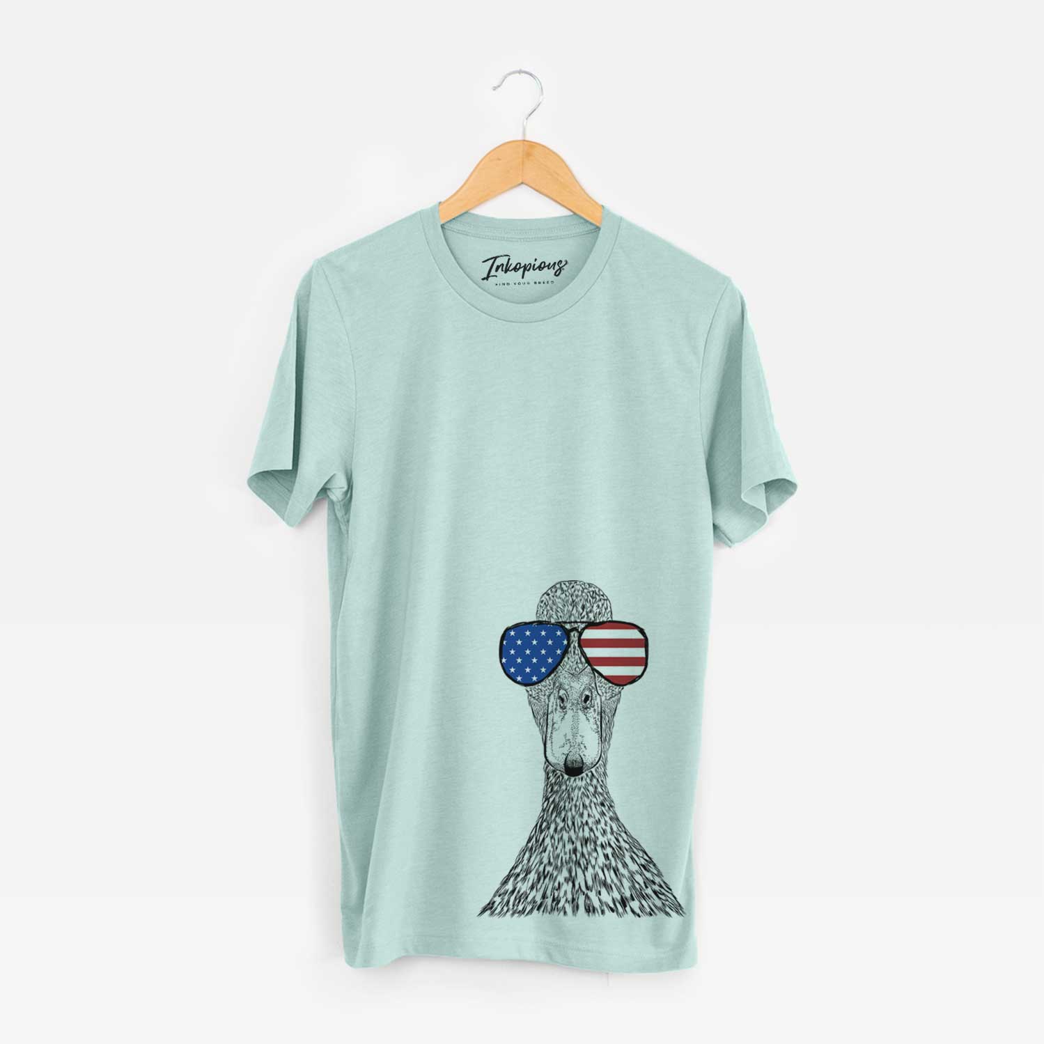 Hand-drawn sketch of Marge the Mallard Duck wearing American flag sunglasses on a Heather Sage Unisex crewneck