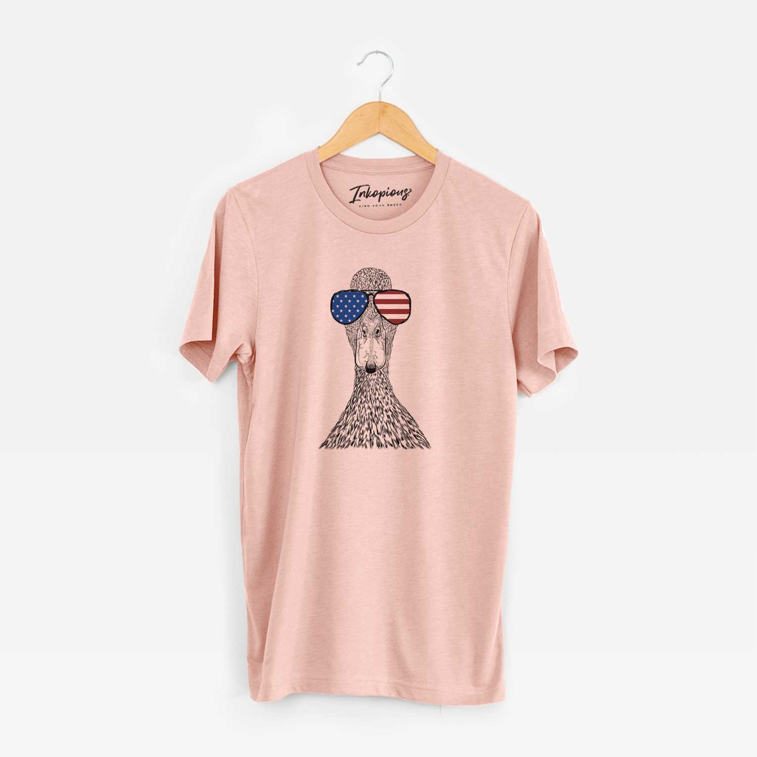 Hand-drawn sketch of Marge the Mallard Duck wearing American flag sunglasses on a Peach Unisex crewneck