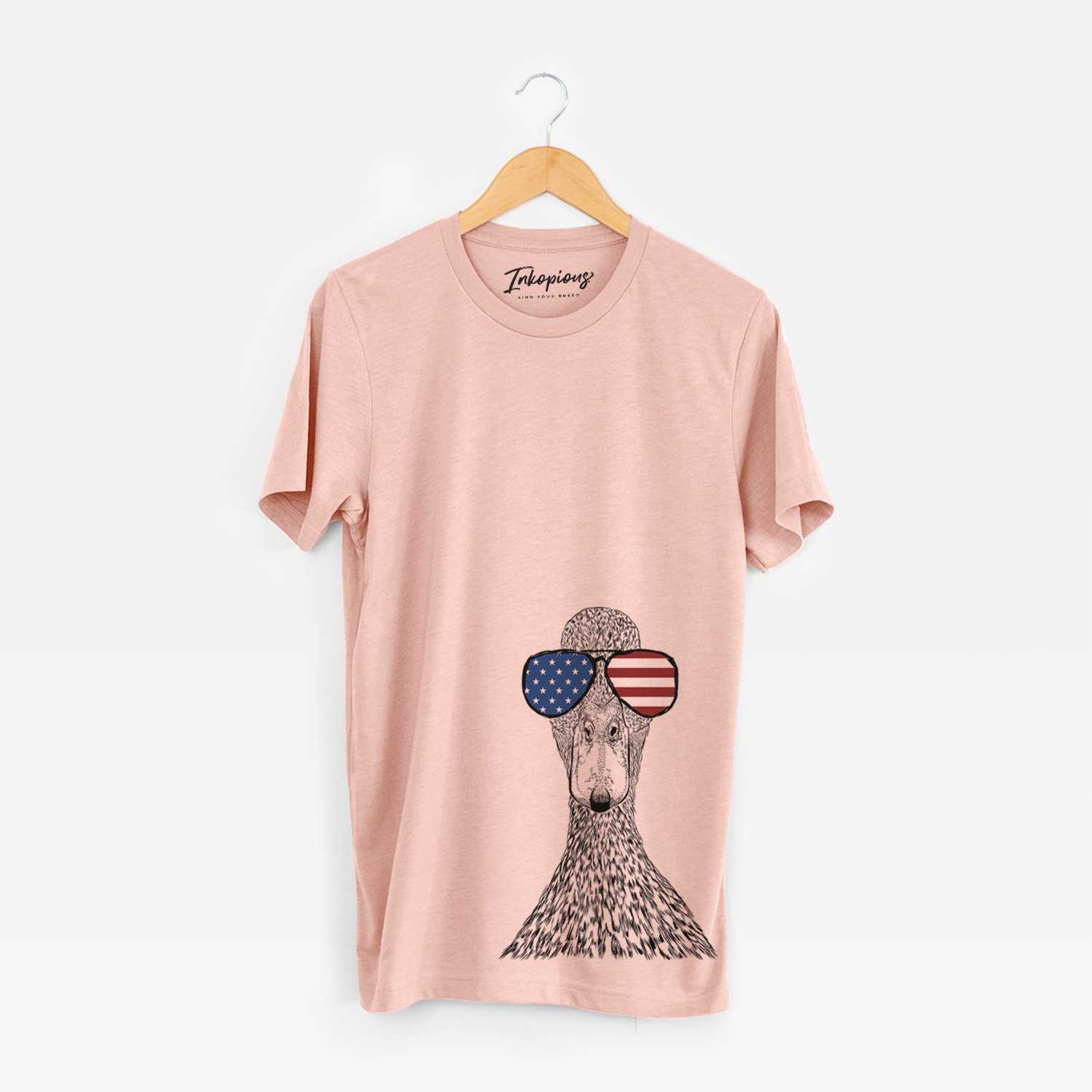 Hand-drawn sketch of Marge the Mallard Duck wearing American flag sunglasses on a Peach Unisex crewneck