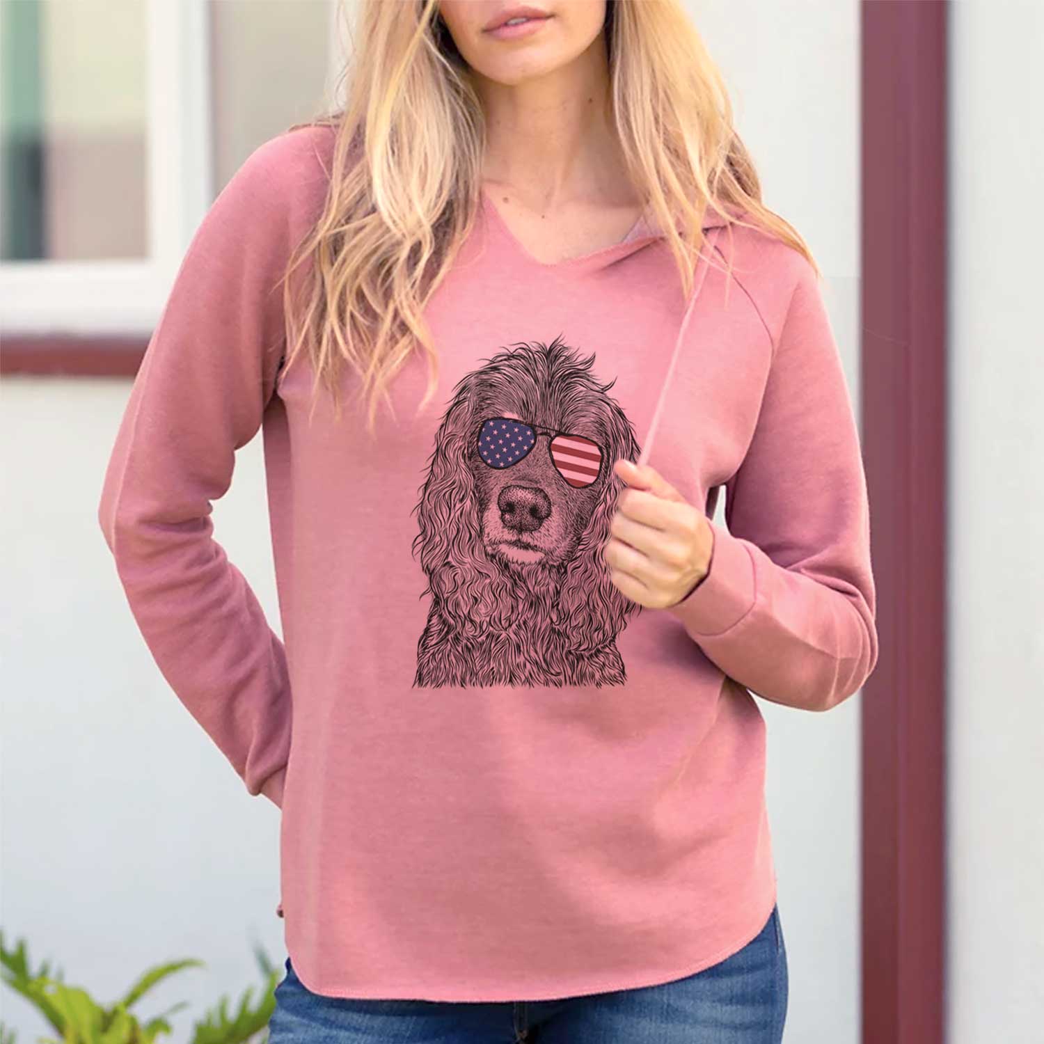 Hand-drawn sketch of Marley Boy the American Cocker Spaniel wearing American flag sunglasses on a Dusty Rose Cali Wave Hooded Sweatshirt, lifestyle photo